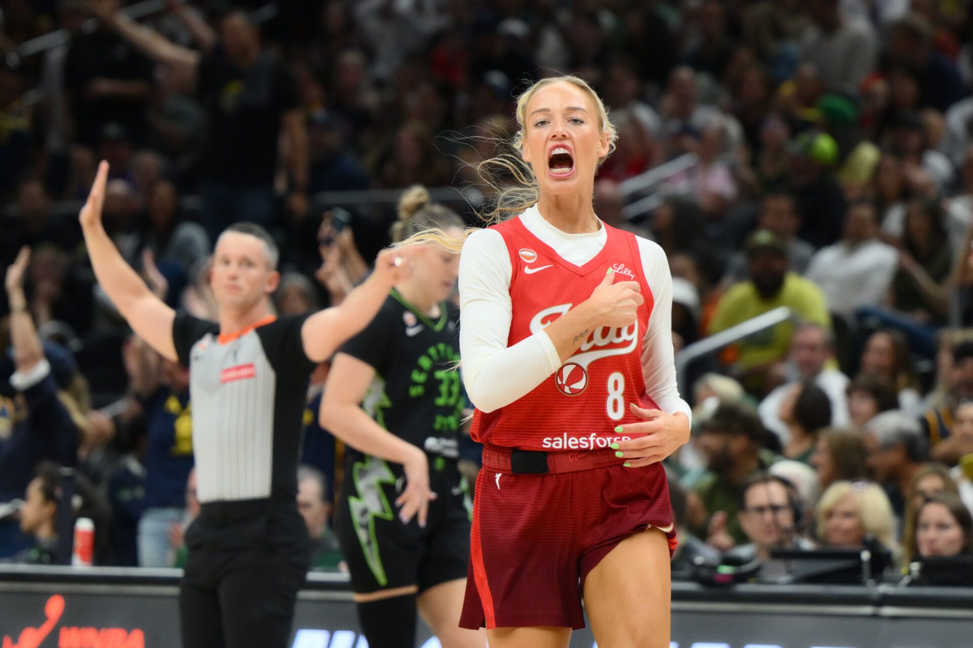Indiana Fever guard Sophie Cunningham (8) celebrates after making a three point shot against the Seattle Storm during the first half at Climate Pledge Arena.