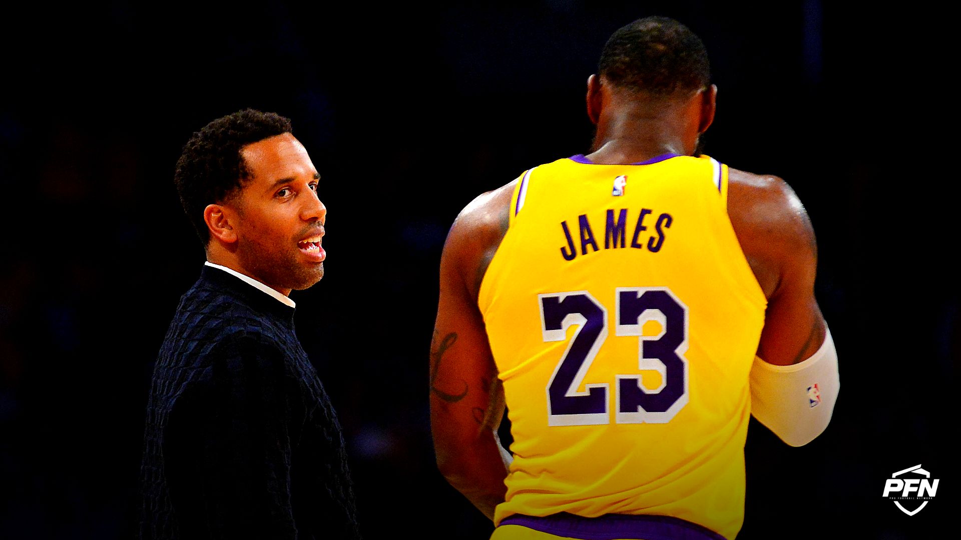 Los Angeles Lakers forward LeBron James (23) speaks with businessman Maverick Carter (left) during a stoppage in play in the second half at Staples Center.