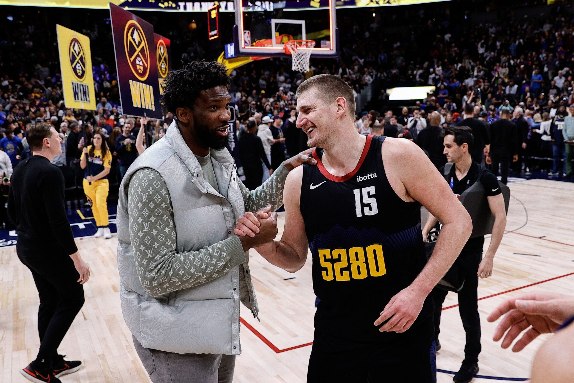 Philadelphia 76ers center Joel Embiid (21) and Denver Nuggets center Nikola Jokic (15) after the game at Ball Arena.