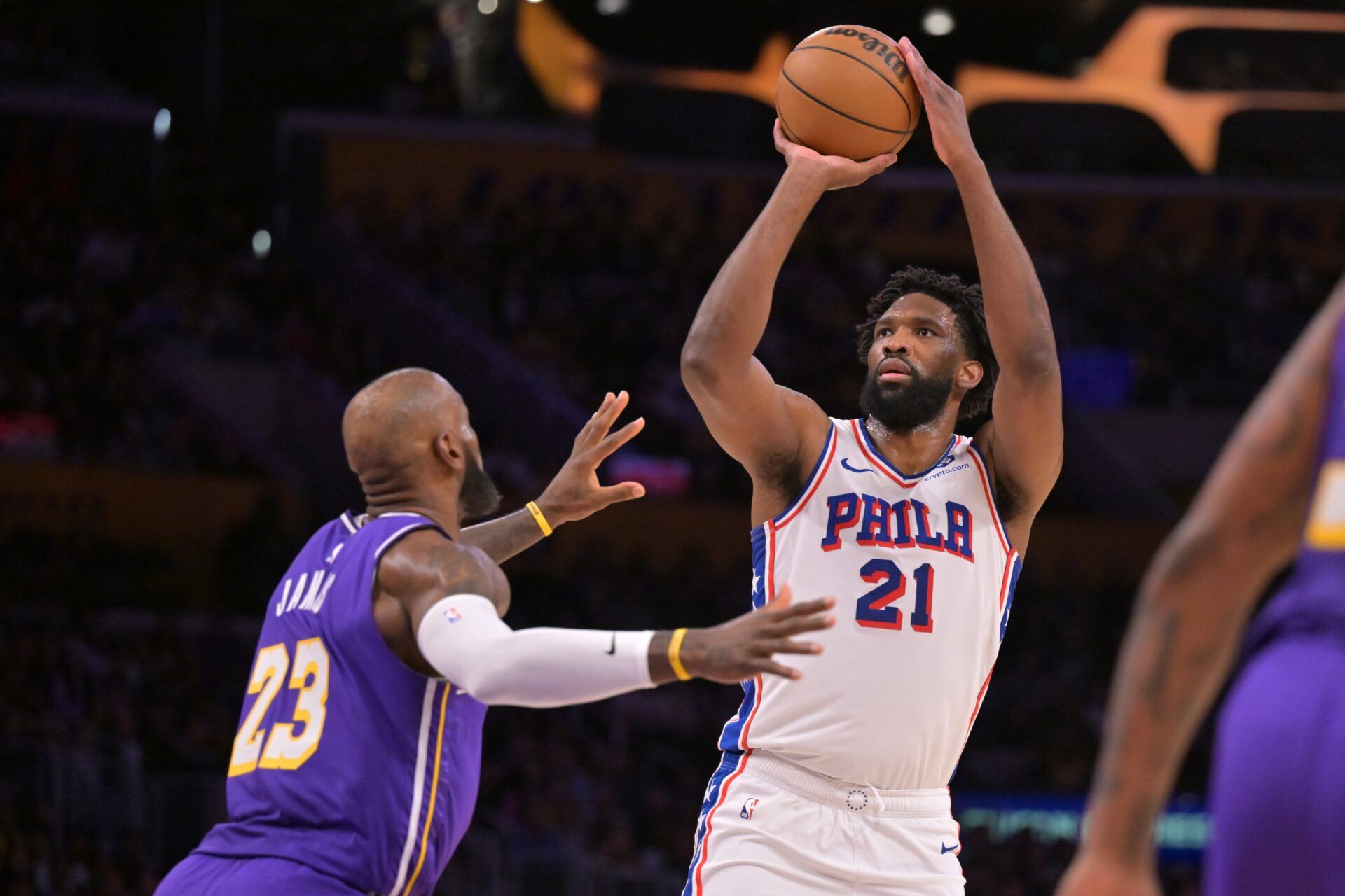 Philadelphia 76ers center Joel Embiid (21) shoots over Los Angeles Lakers forward LeBron James (23) in the first half at Crypto.com Arena.