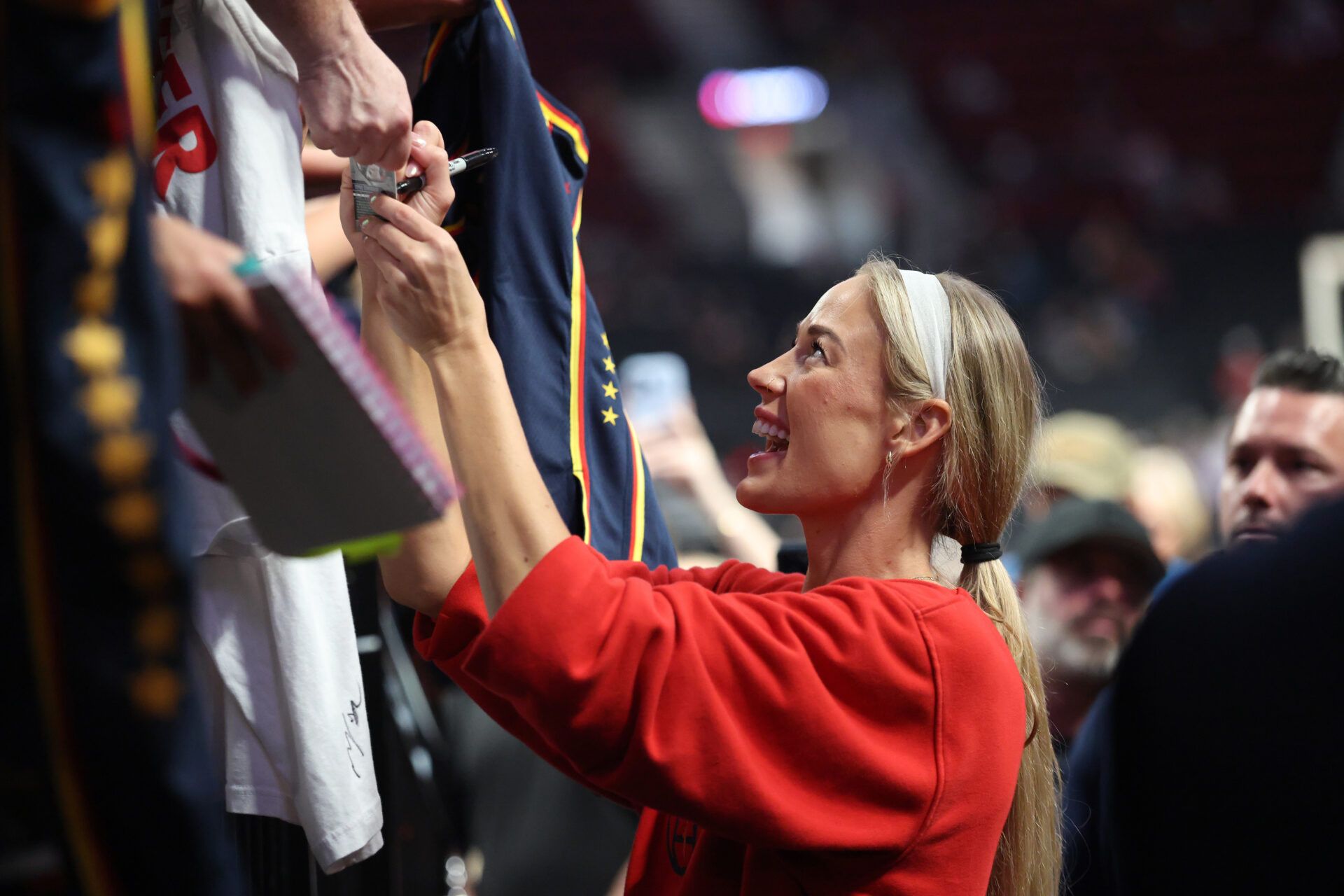 Indiana Fever guard Sophie Cunningham (8) signs autographs for fans before a game against the Portland Fire at Moda Center.