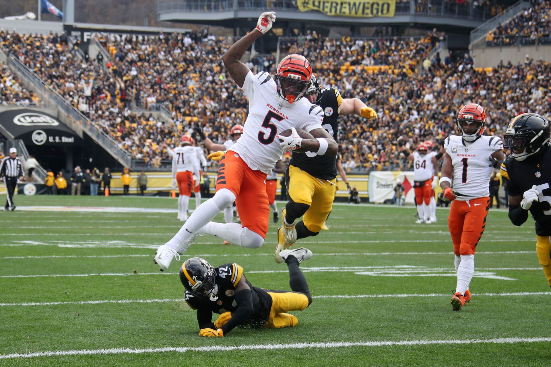 Cincinnati Bengals wide receiver Tee Higgins (5) scores a touchdown against Pittsburgh Steelers cornerback James Pierre (42) during the first half against at Acrisure Stadium.