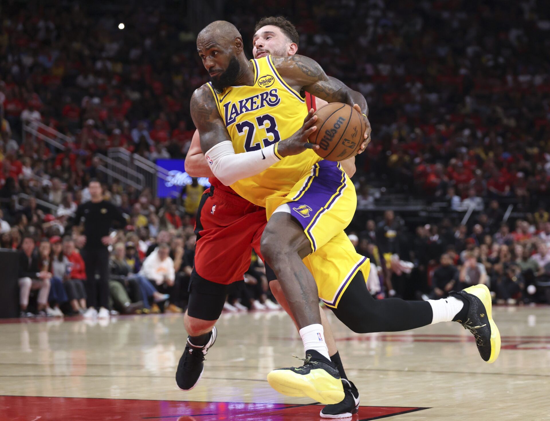 Los Angeles Lakers forward LeBron James (23) drives with the ball as Houston Rockets center Alperen Sengun (28) defends during the fourth quarter during game three of the first round of the 2026 NBA Playoffs at Toyota Center.