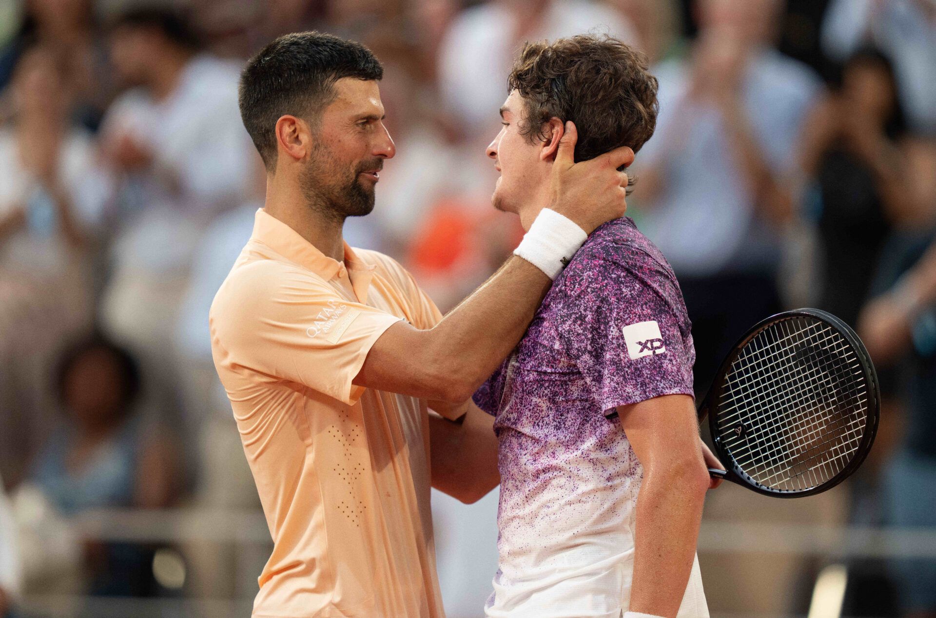 Joao Fonseca of Brazil and Novak Djokovic of Serbia at the net after their match on day six at Stade Roland Garros.