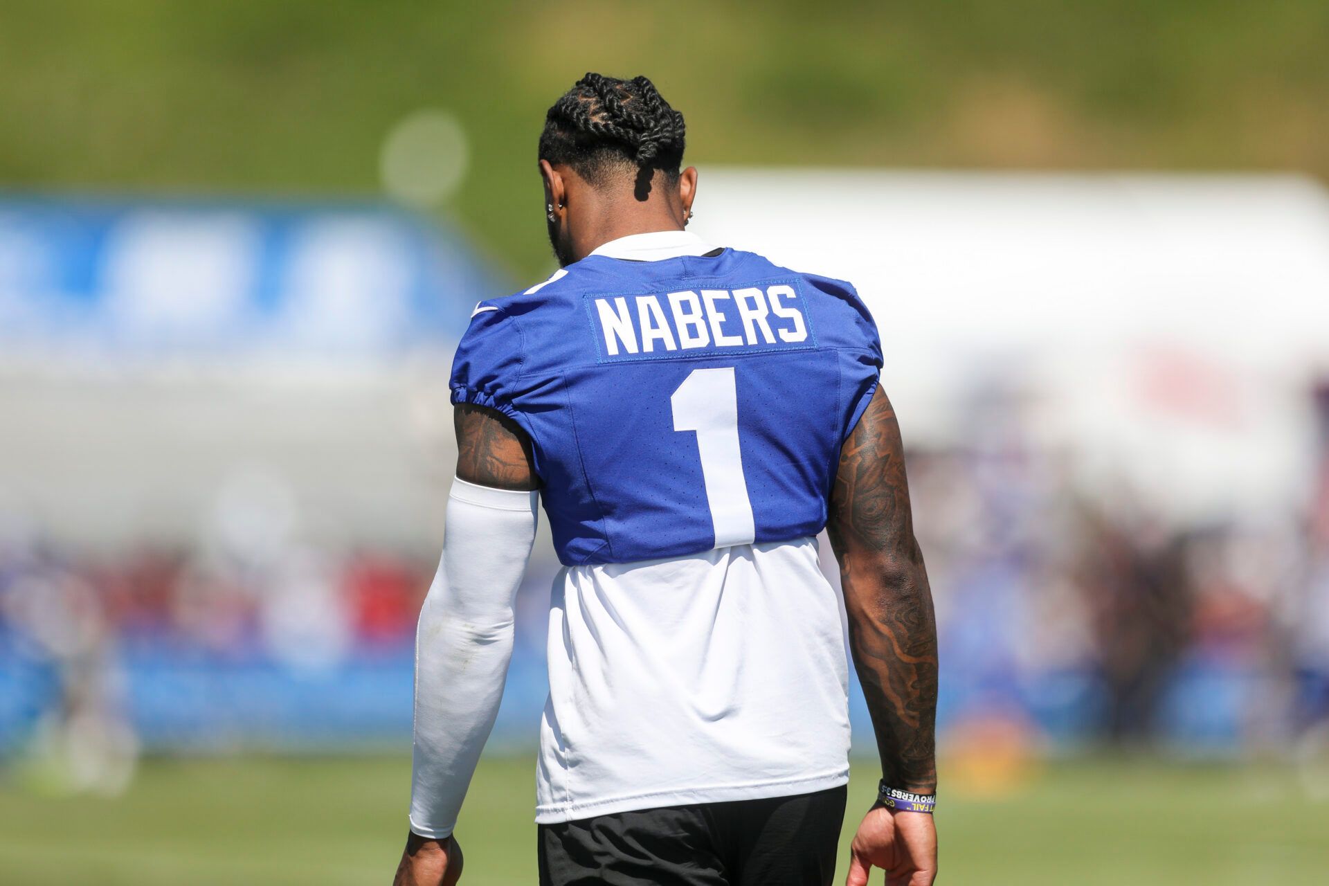 New York Giants wide receiver Malik Nabers (1) walks on the field after practice during training camp at The Greenbrier Resort Sports Performance Center.