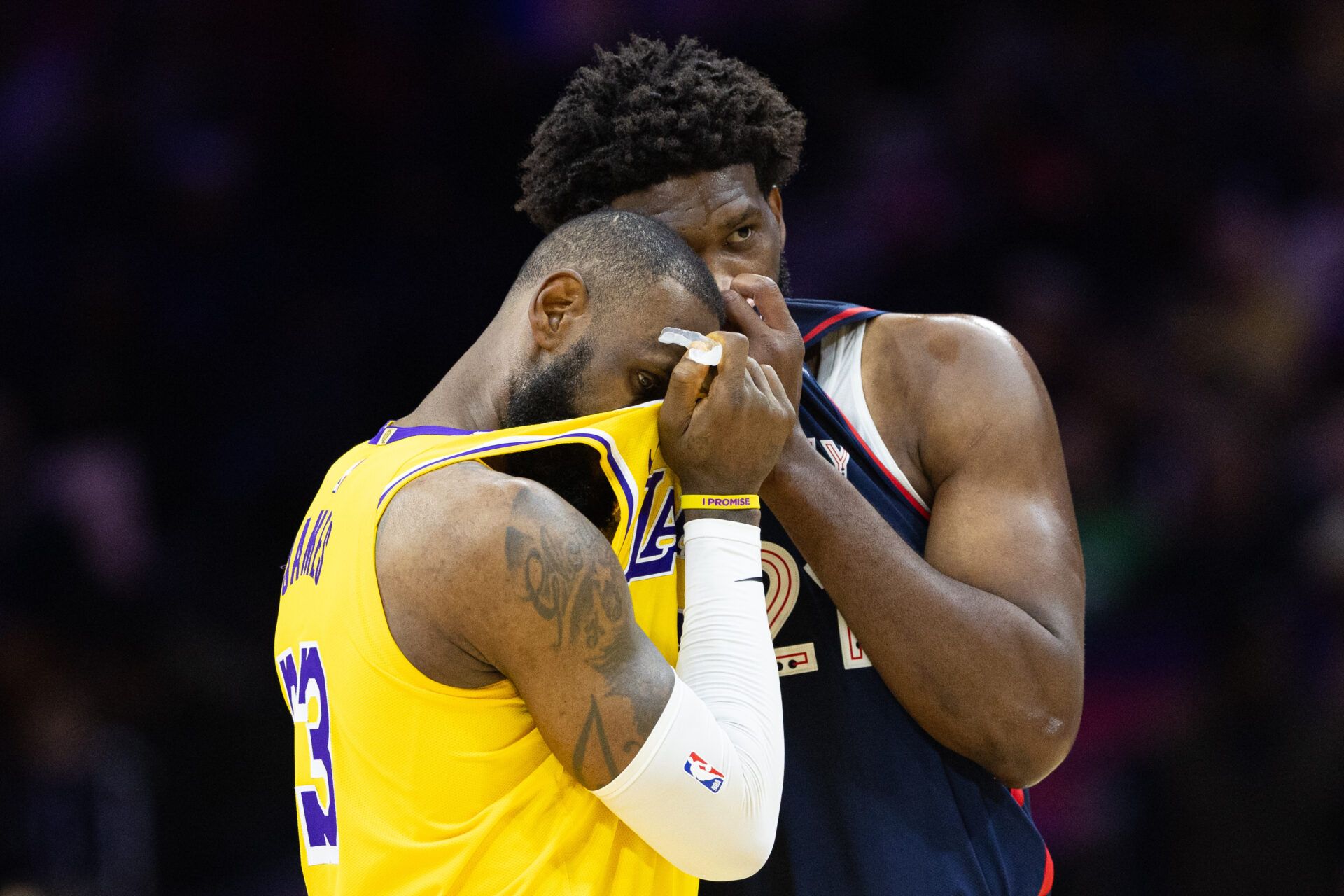 Philadelphia 76ers center Joel Embiid (21) talks with Los Angeles Lakers forward LeBron James (23) during the second quarter at Wells Fargo Center.