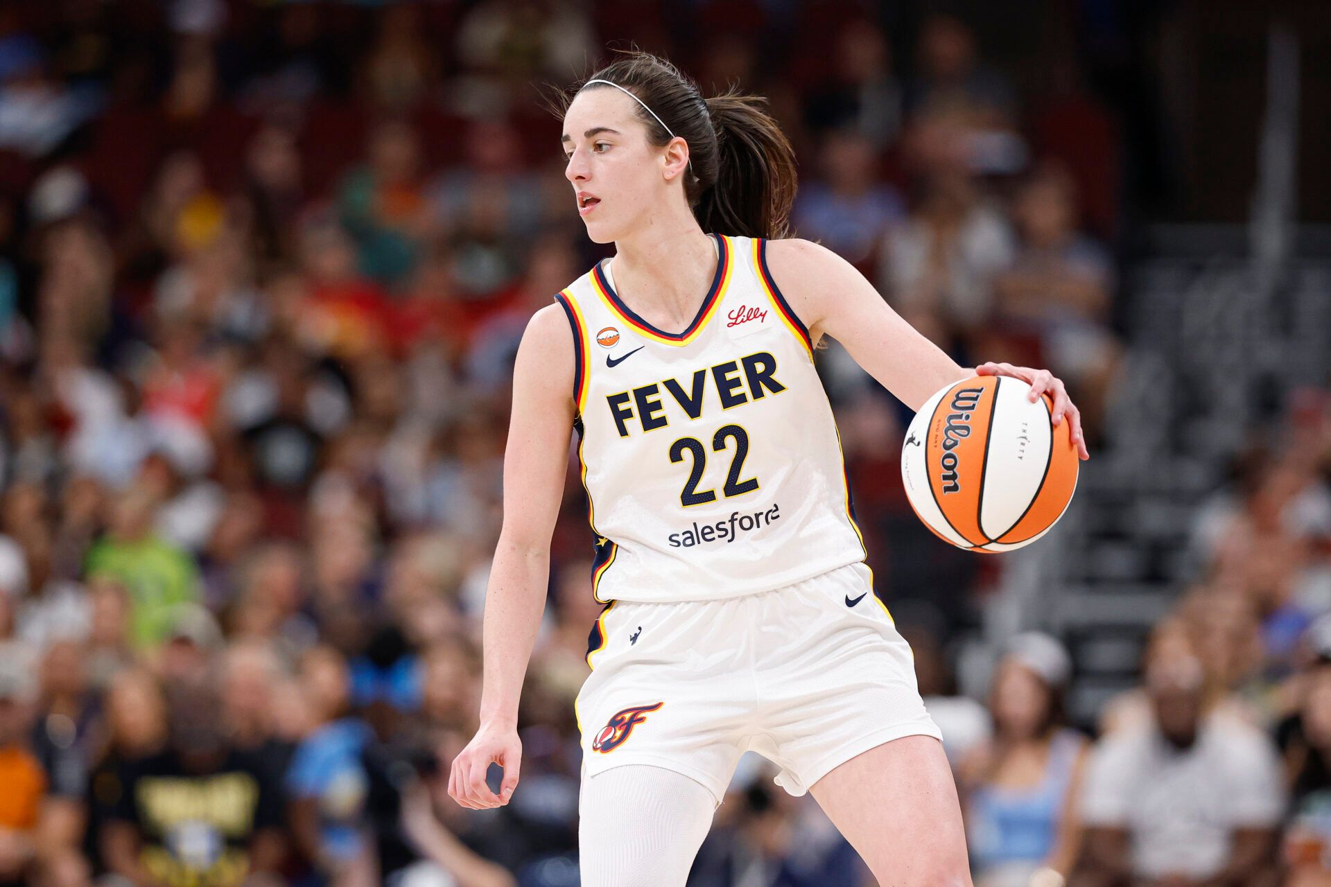 Indiana Fever guard Caitlin Clark (22) brings the ball up court against the Chicago Sky during the first half at United Center.