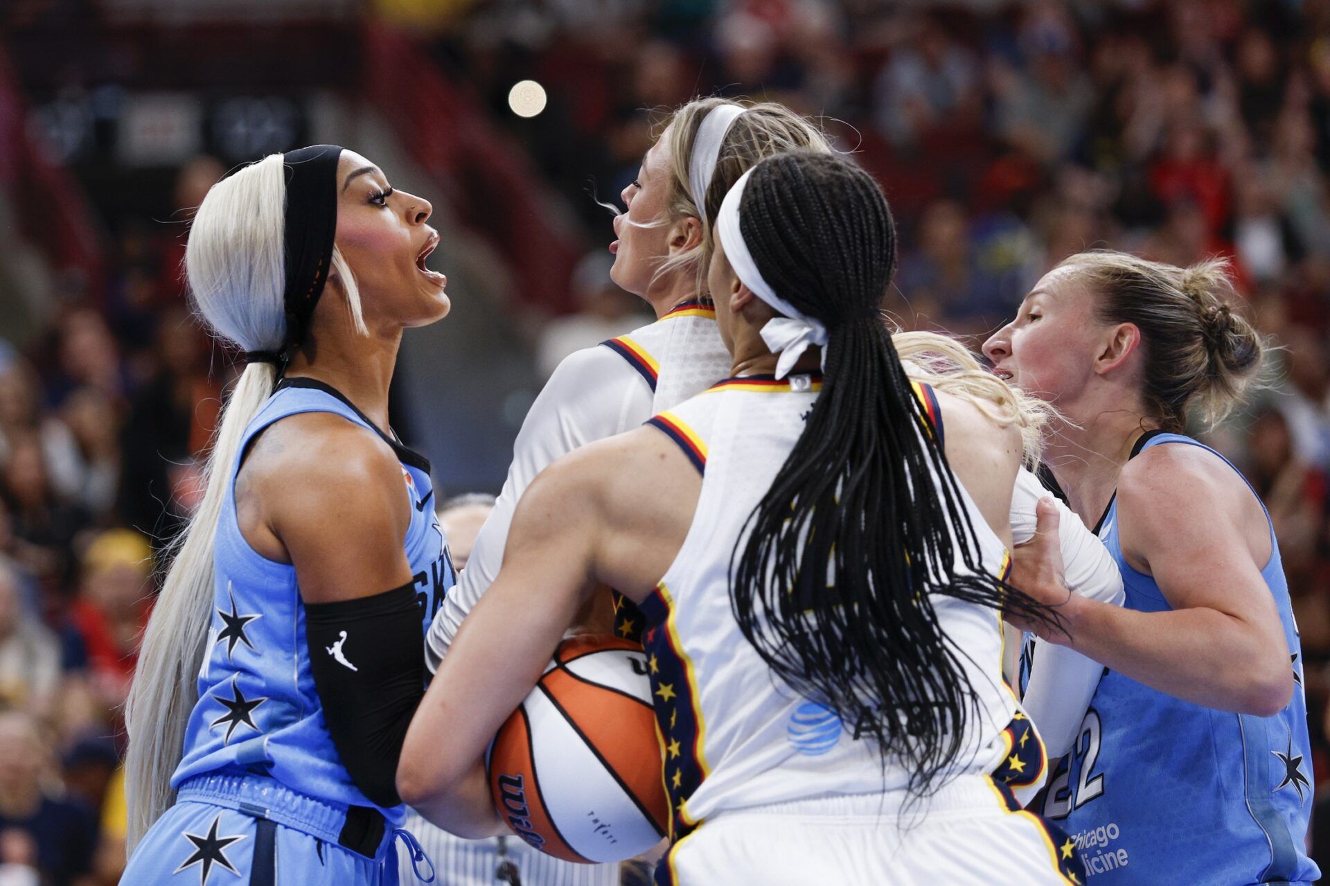 Indiana Fever guard Sophie Cunningham (8) fights with Chicago Sky guard DiJonai Carrington (7) after she was fouled during the first half at United Center.