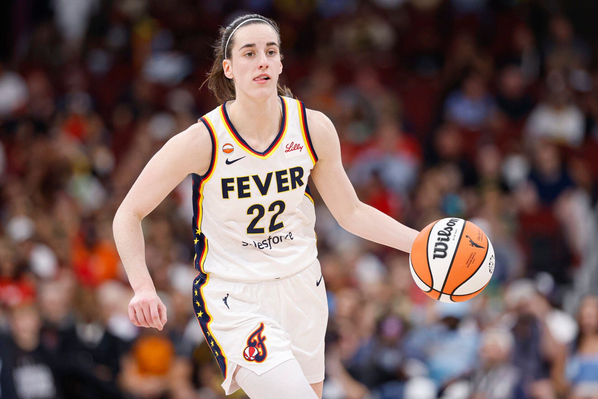 Indiana Fever guard Caitlin Clark (22) brings the ball up court against the Chicago Sky during the first half at United Center.