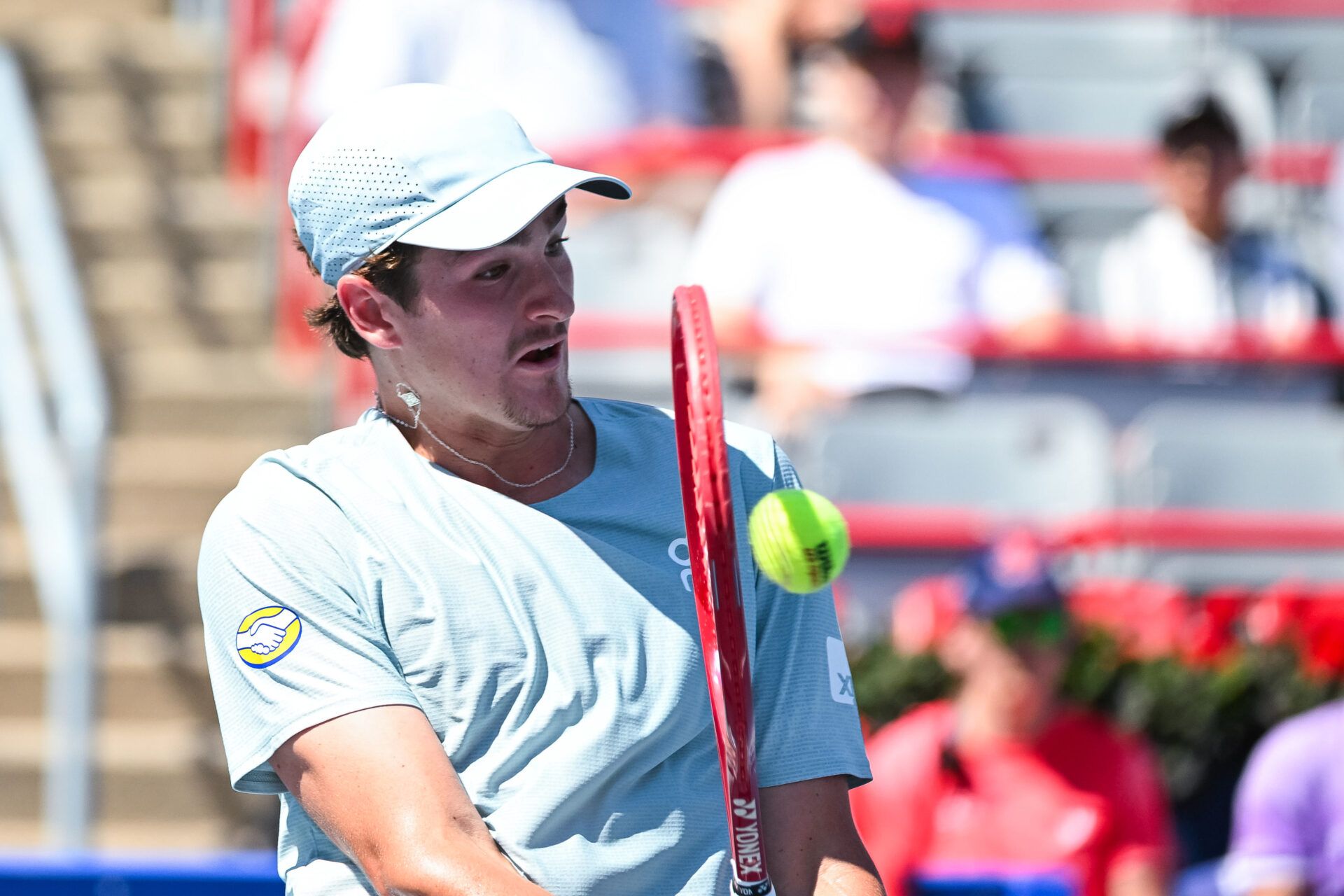 Joao Fonseca (BRA) returns the ball to Stefanos Tsitsipas (GRE) in second round play at IGA Stadium.
