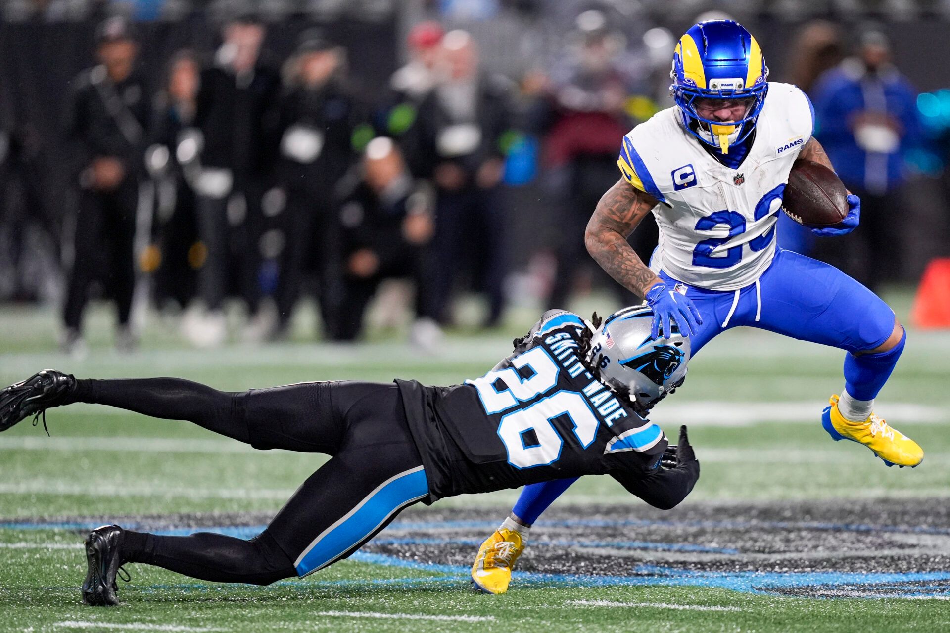 Los Angeles Rams running back Kyren Williams (23) eludes Carolina Panthers cornerback Chau Smith-Wade (26) during the second half of the NFC Wild Card Round game between the Carolina Panthers and the Los Angeles Rams at Bank of America Stadium.