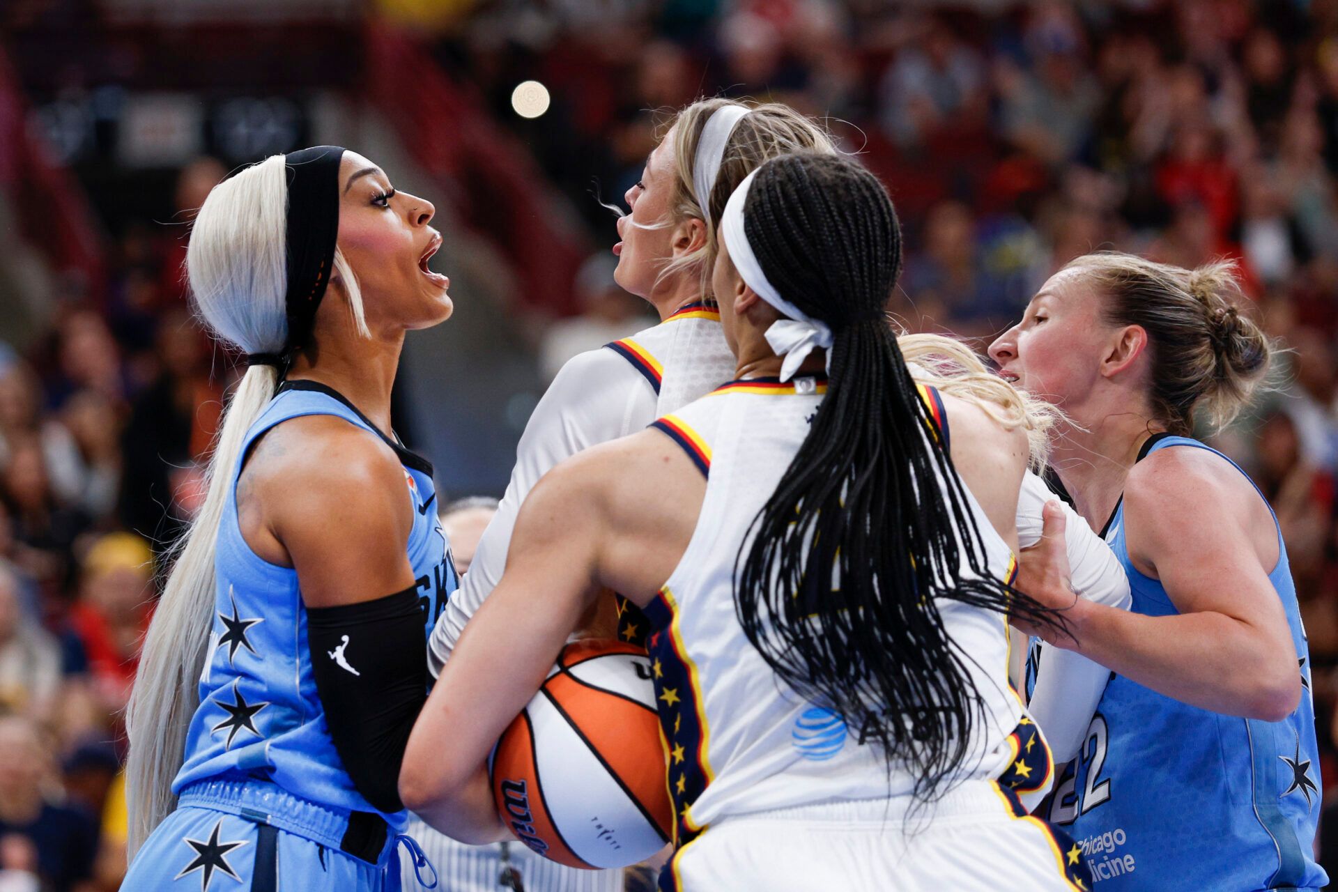 Indiana Fever guard Sophie Cunningham (8) fights with Chicago Sky guard DiJonai Carrington (7) after she was fouled during the first half at United Center.