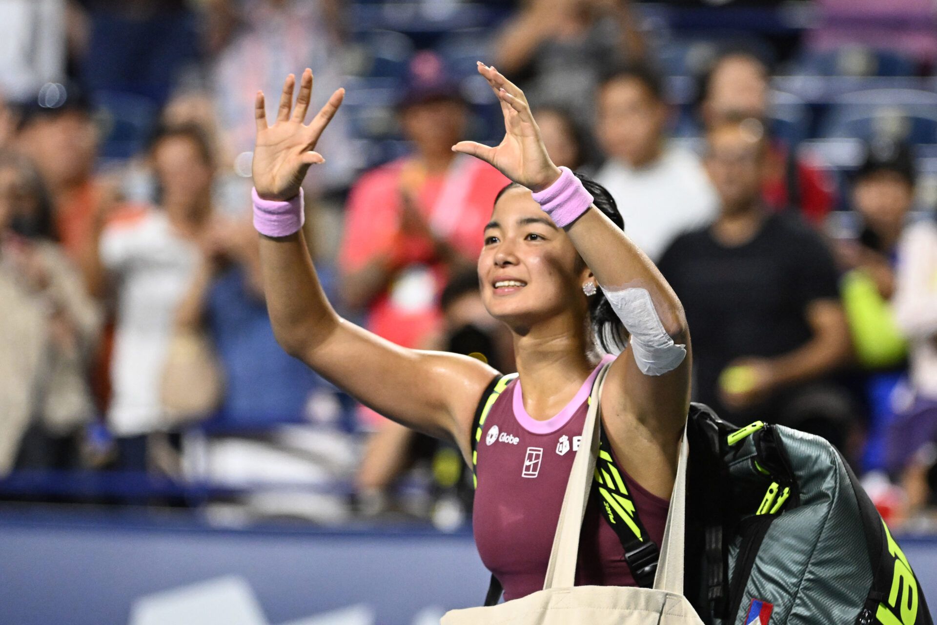 Alexandra Eala (PHI) waves to fans as she leaves the court after losing to Belinda Bencic (SUI) during fourth round play at Sobeys Stadium.
