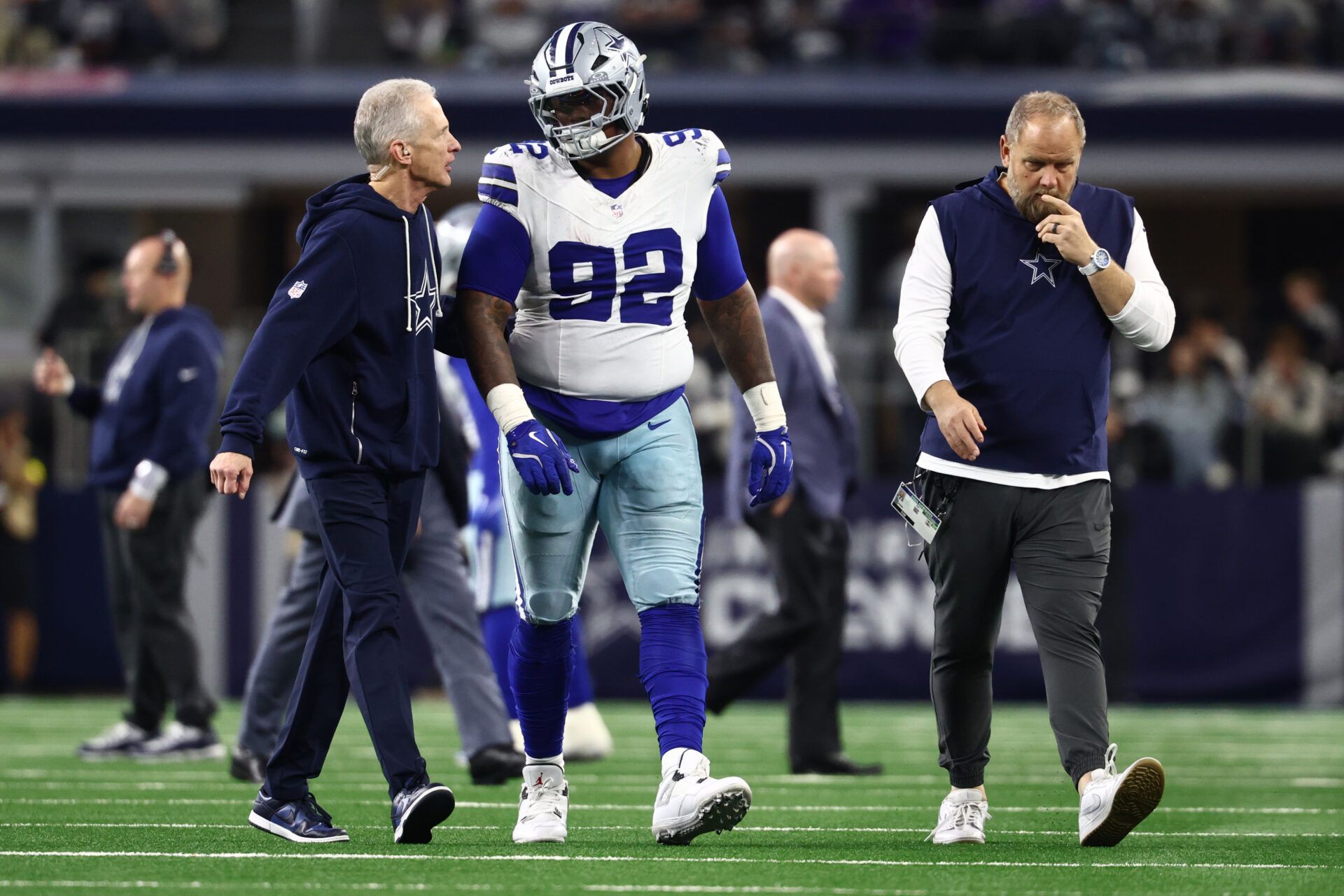 Dallas Cowboys defensive tackle Quinnen Williams (92) walks off the field with trainers after an injury during the second half against the Minnesota Vikings at AT&T Stadium.