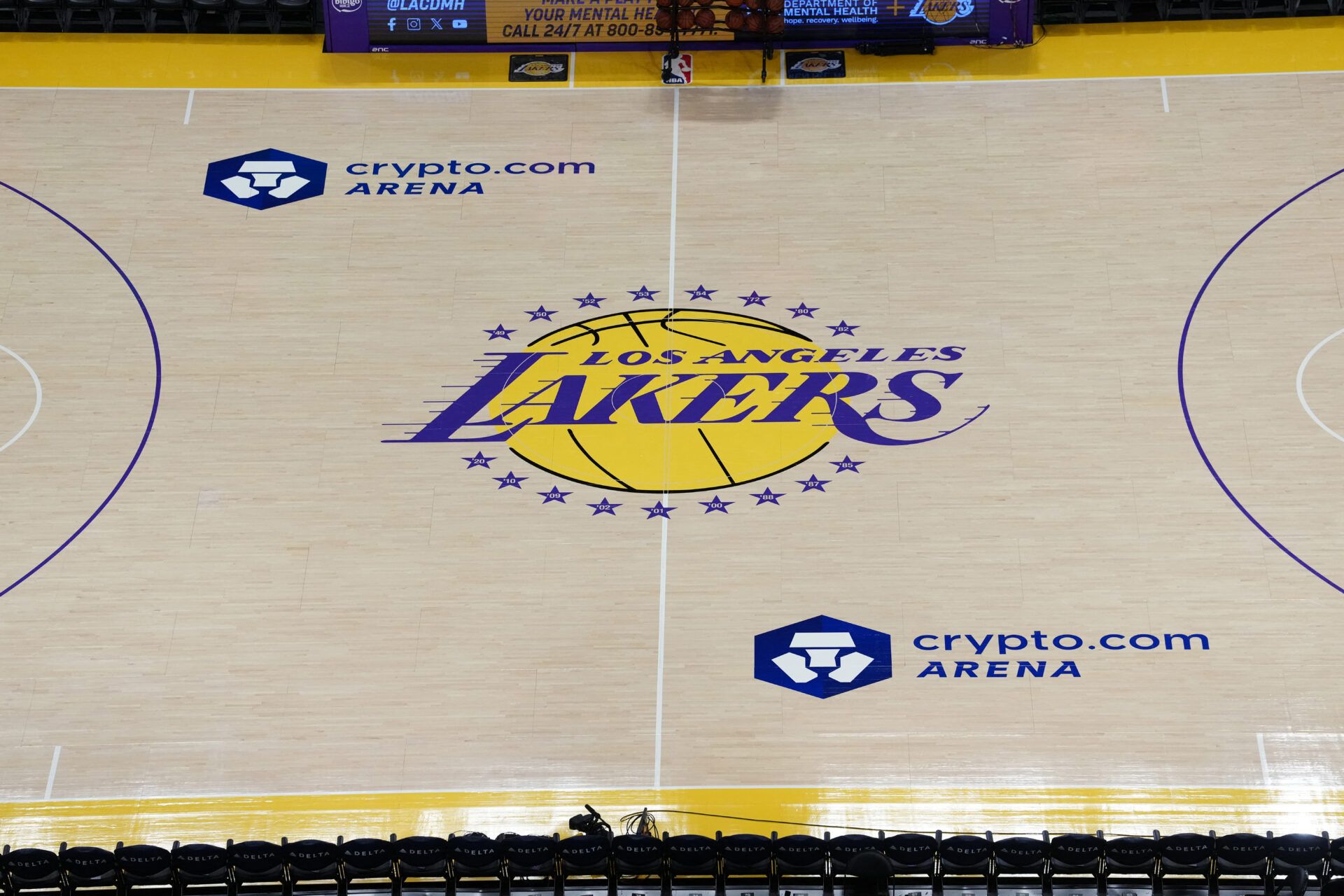 The Los Angeles Lakers logo at midcourt at the Crypto.com Arena.