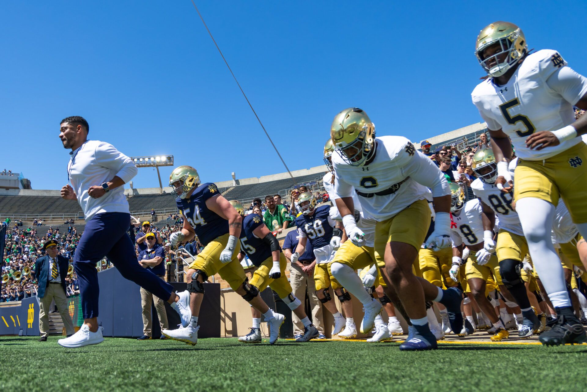 Notre Dame Fighting Irish head coach Marcus Freeman runs out with the team before the Blue-Gold game at Notre Dame Stadium.