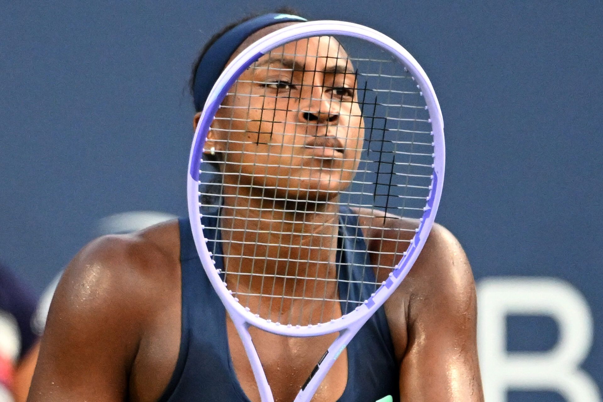 Coco Gauff (USA) looks through the strings of her racquet as she waits to receive serve from Maria Sakkari (GRE) during third round play at Sobeys Stadium.