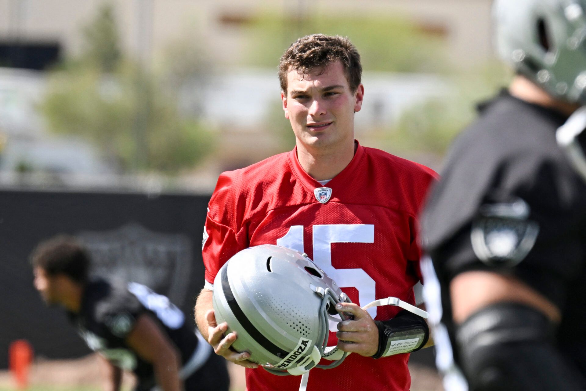 Las Vegas Raiders quarterback Fernando Mendoza (15) warms up during organized team activities at Intermountain Health Performance Center.
