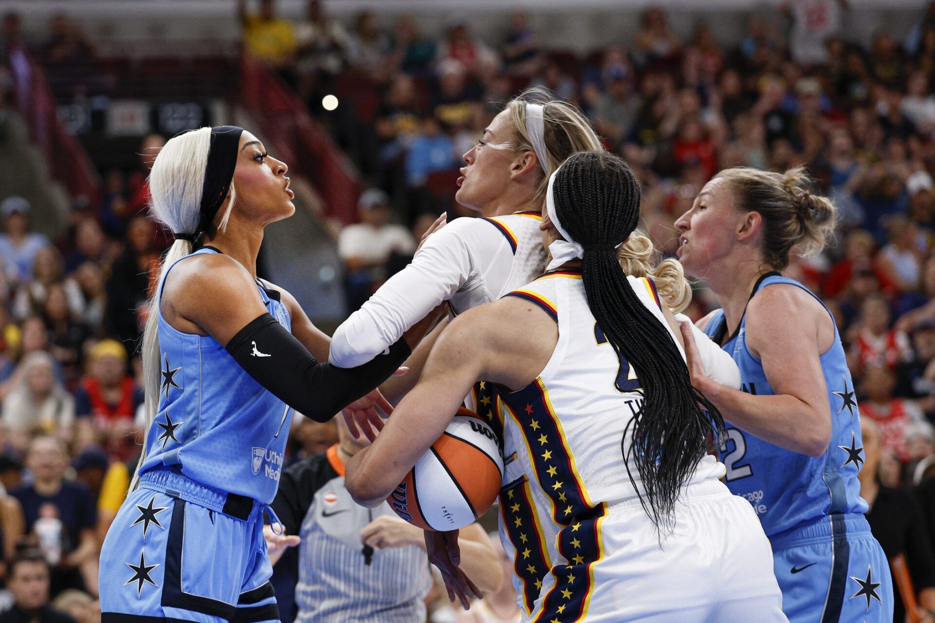 Indiana Fever guard Sophie Cunningham (8) reacts after being fouled by Chicago Sky guard DiJonai Carrington (7) during the first half of a WNBA game at United Center.