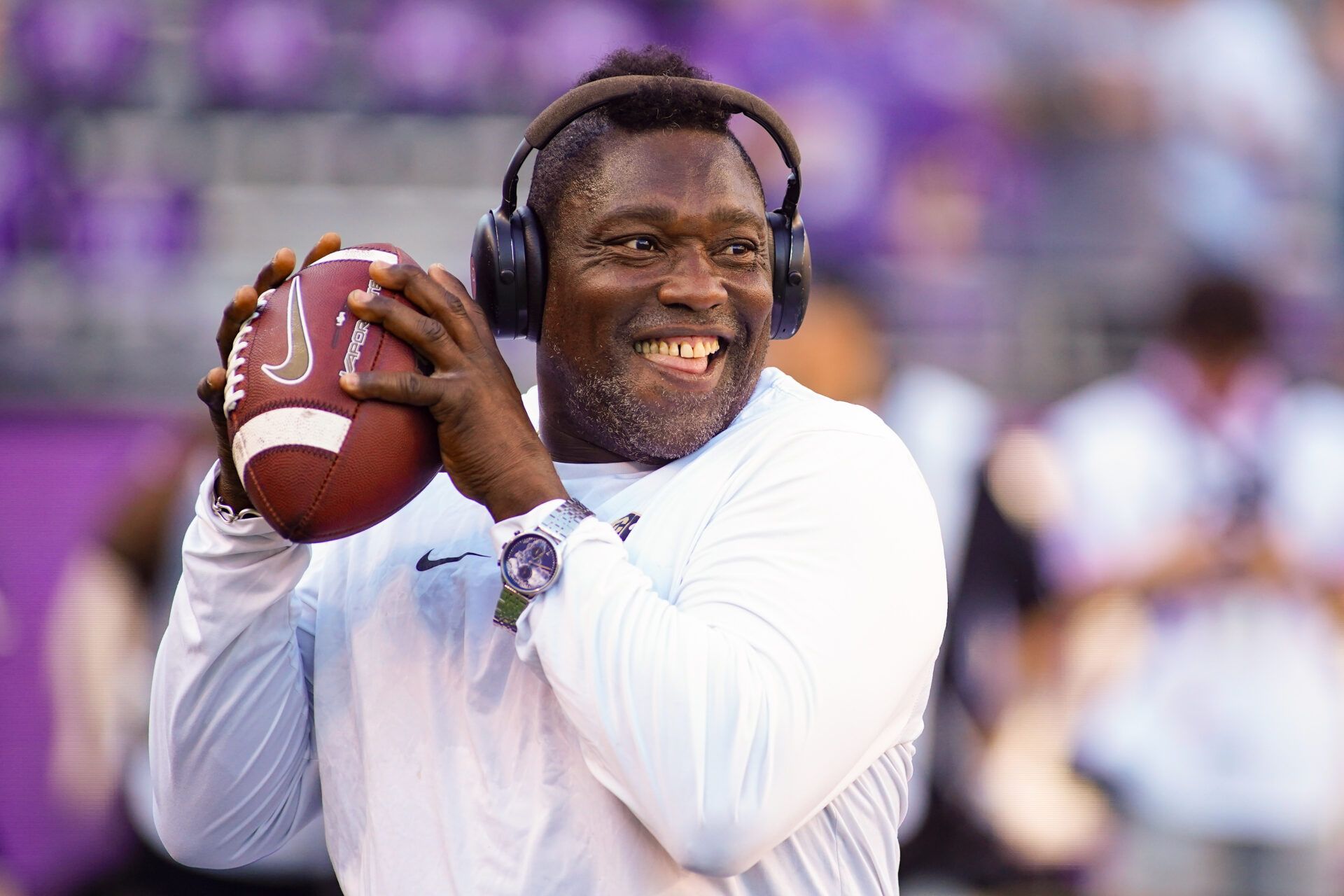 Colorado Buffaloes defensive pass rush coordinator Warren Sapp plays catch on the sidelines prior to a game between the TCU Horned Frogs and the Colorado Buffaloes at Amon G. Carter Stadium.