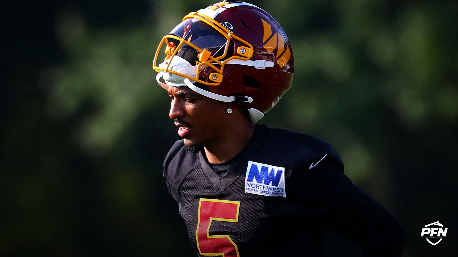 Washington Commanders quarterback Jayden Daniels (5) stands on the field during a drill on day one of training camp at BigBear.ai Performance Center at Commanders Park.