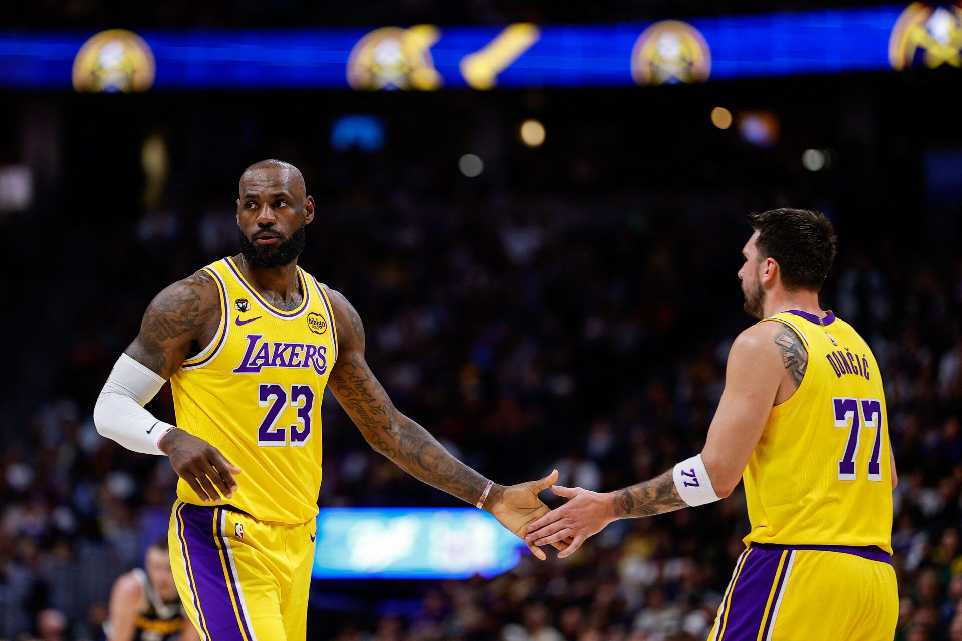 Los Angeles Lakers forward LeBron James (23) and guard Luka Doncic (77) in the first quarter against the Denver Nuggets at Ball Arena.