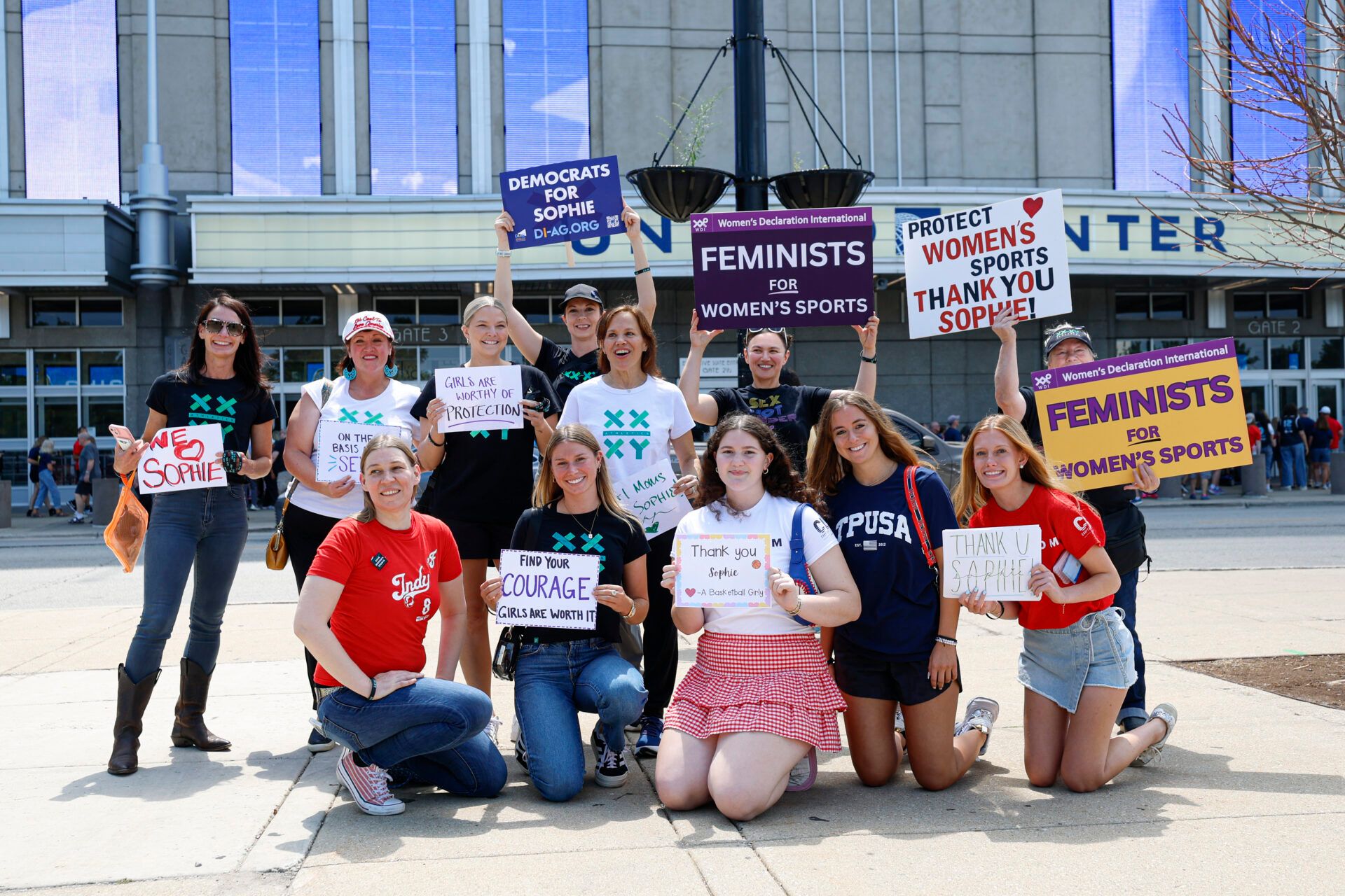 Protesters hold signs outside United Center before a WNBA game between the Chicago Sky and Indiana Fever.