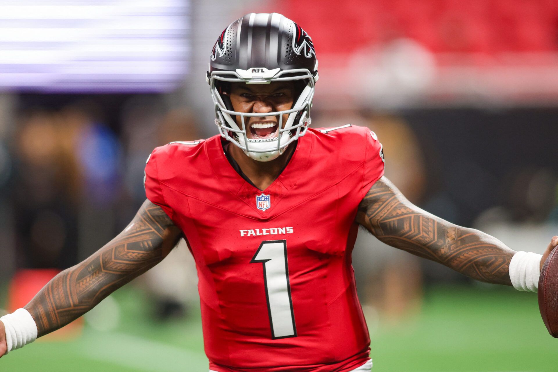 Atlanta Falcons quarterback Tua Tagovailoa (1) warms up before a game against the Denver Broncos at Mercedes-Benz Stadium.
