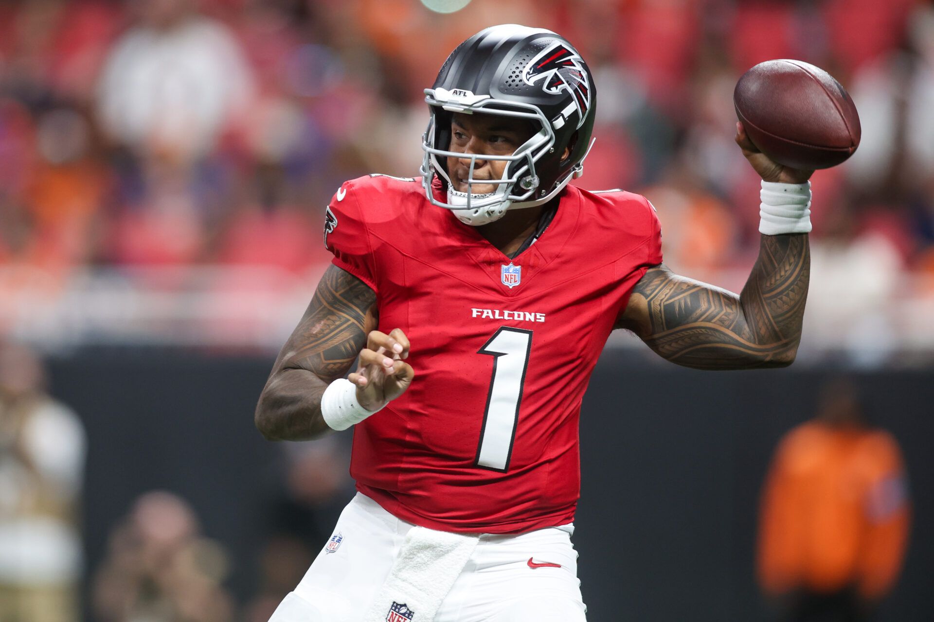 Atlanta Falcons quarterback Tua Tagovailoa (1) throws a pass against the Denver Broncos in the first quater at Mercedes-Benz Stadium.