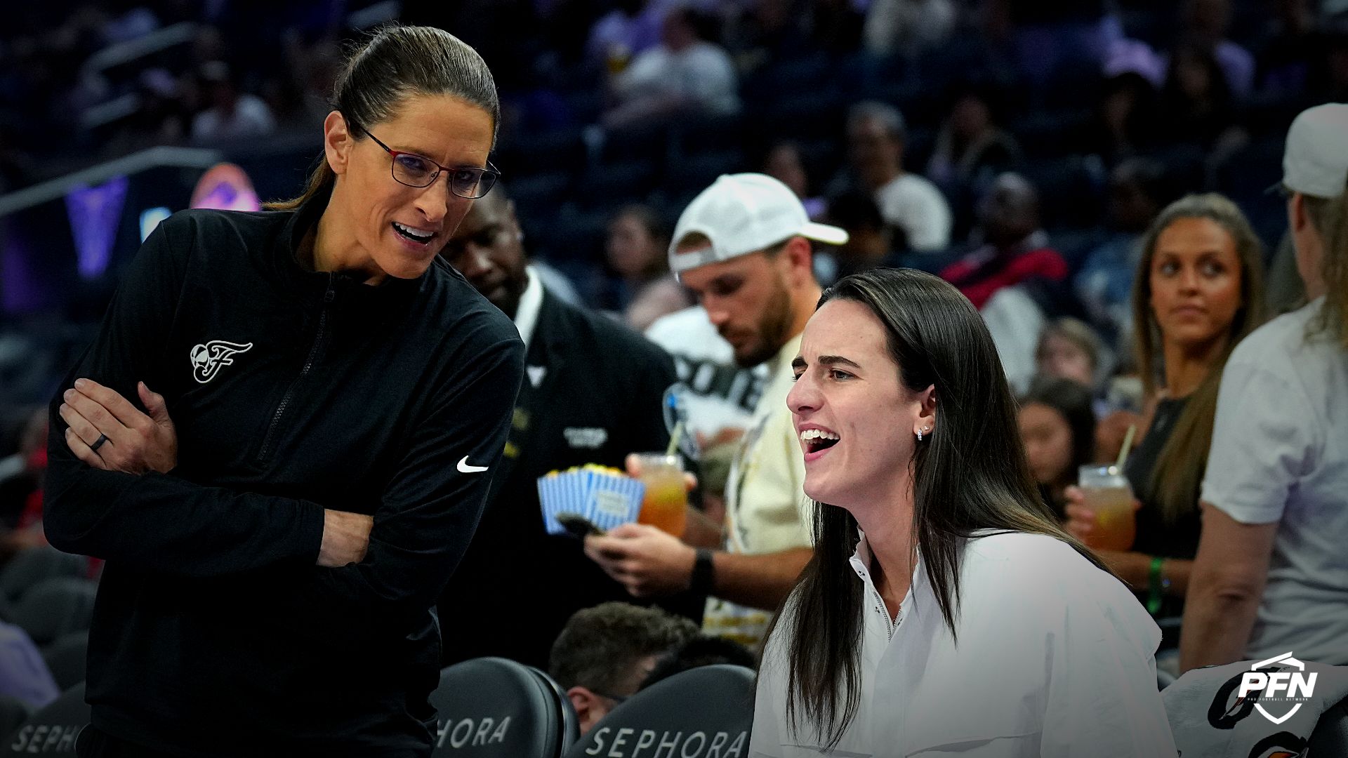 Indiana Fever head coach Stephanie White (center left) and guard Caitlin Clark (center right) talk before the game against the Golden State Valkyries at Chase Center.