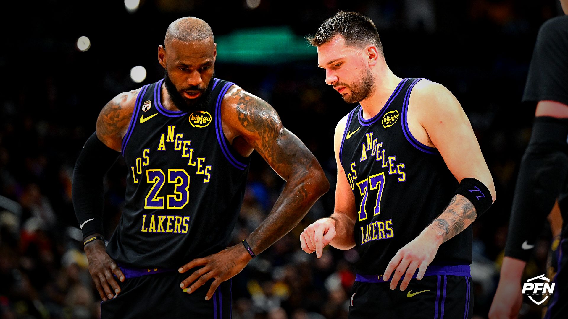 Los Angeles Lakers forward/guard Luka Doncic (77) talks with Los Angeles Lakers forward LeBron James (23) against the Washington Wizards during the second half at Capital One Arena.