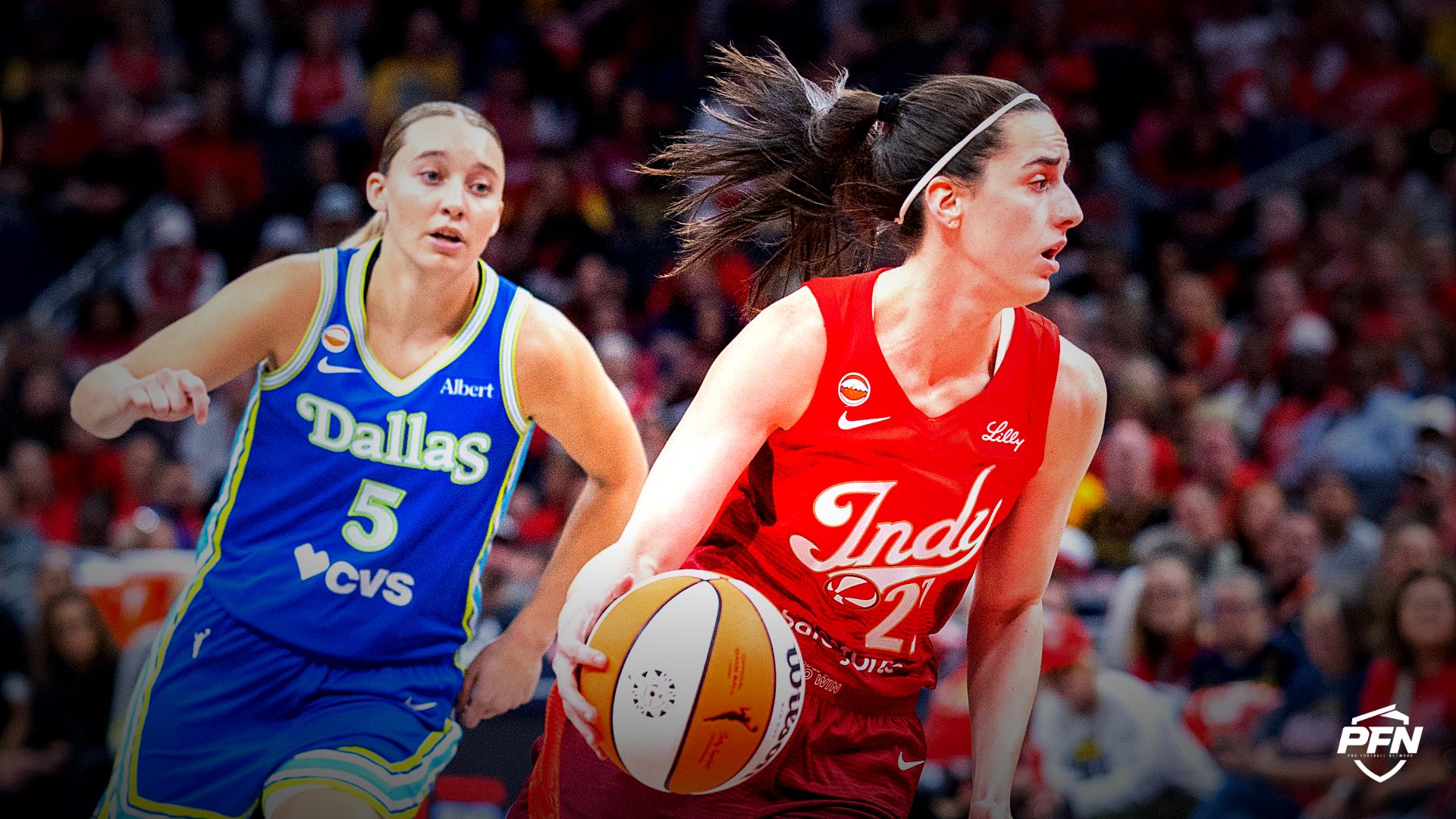 Indiana Fever guard Caitlin Clark (22) dribbles the ball while Dallas Wings guard Paige Bueckers (5) defends in the first half at Gainbridge Fieldhouse.