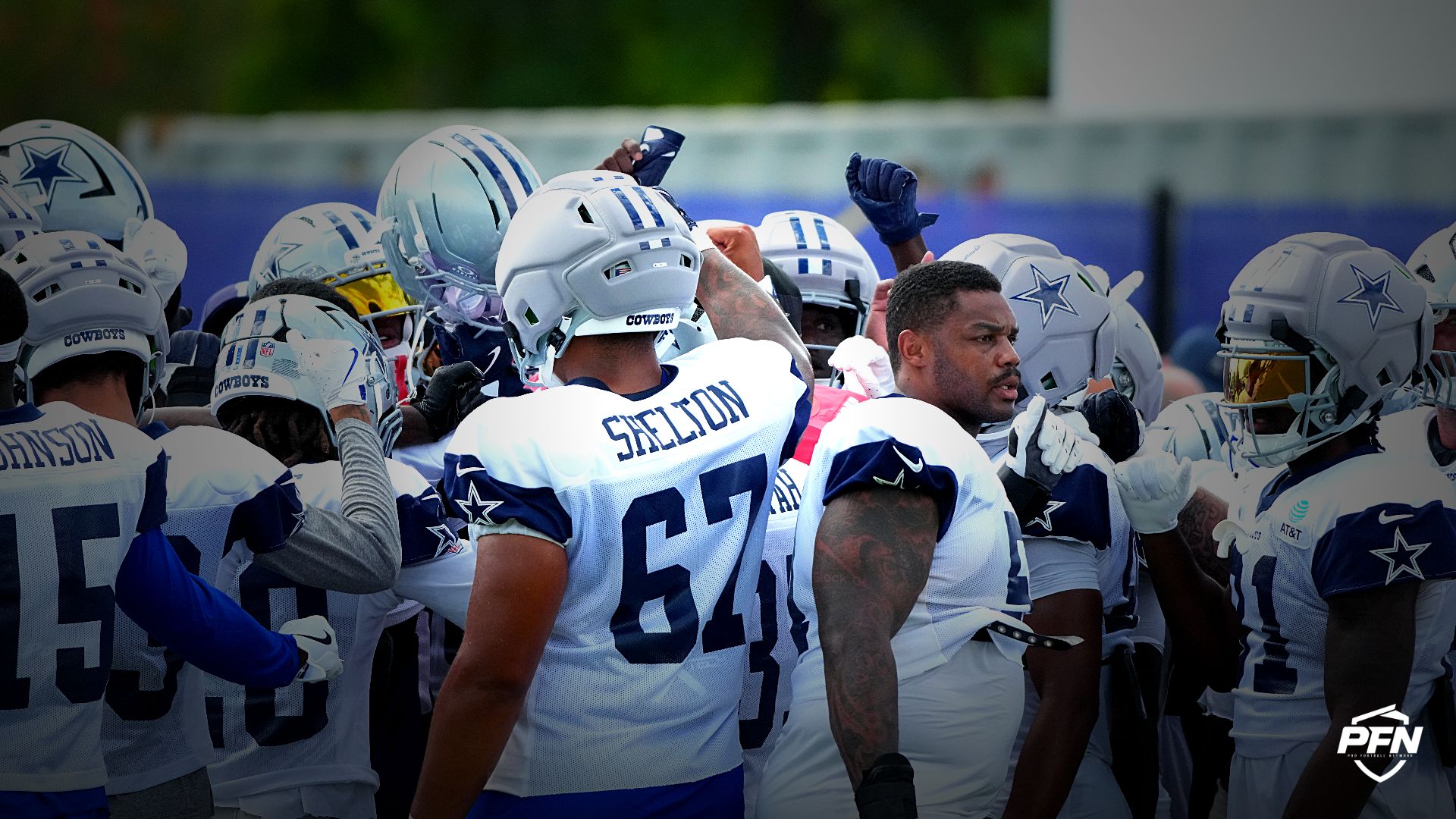 Cowboys players huddle during a joint practice.