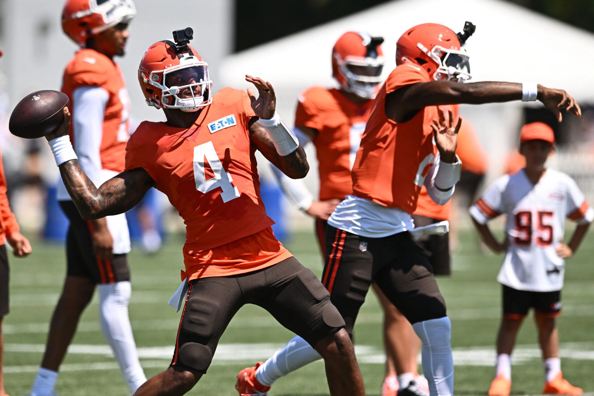 Cleveland Browns quarterback Deshaun Watson (4) and quarterback Shedeur Sanders (2) throw passes during training camp at CrossCountry Mortgage Campus.