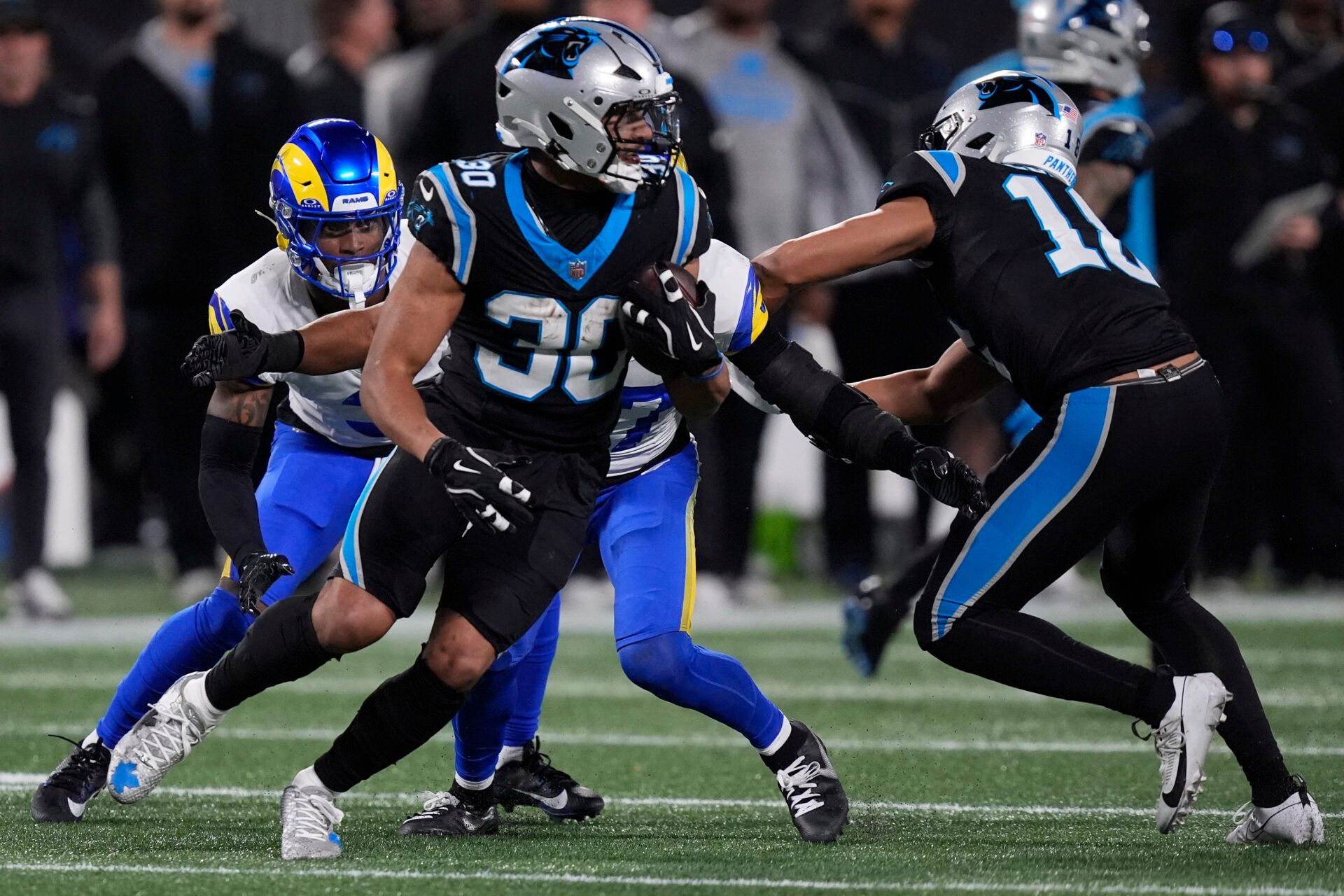 Carolina Panthers running back Chuba Hubbard (30) rushes the ball against the Los Angeles Rams in the second half during the NFC Wild Card Round game at Bank of America Stadium.
