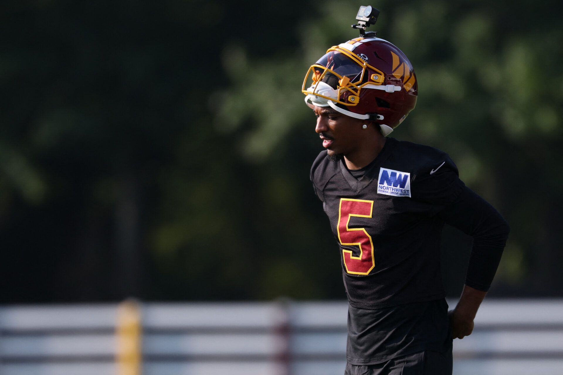 Washington Commanders quarterback Jayden Daniels (5) stands on the field during a drill on day one of training camp at BigBear.ai Performance Center at Commanders Park.