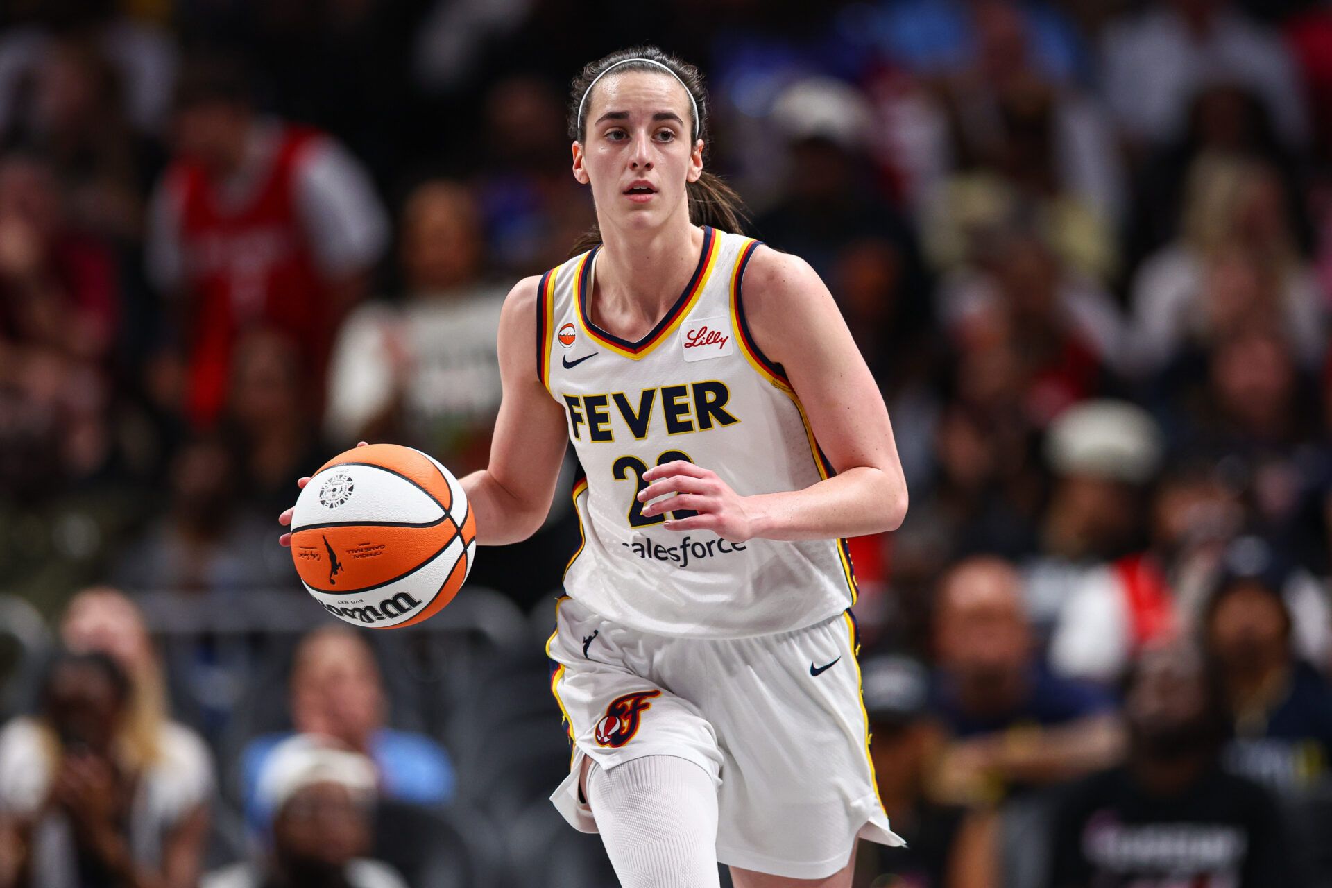 Indiana Fever guard Caitlin Clark (22) dribbles against the Atlanta Dream during the first quarter at State Farm Arena.