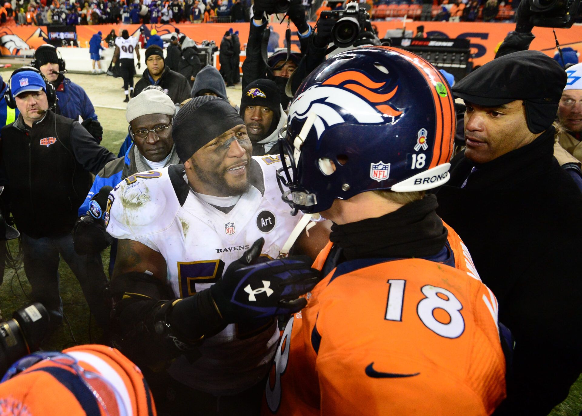 Baltimore Ravens linebacker Ray Lewis (52) is congratulated by Denver Broncos quarterback Peyton Manning following the AFC divisional round playoff game at Sports Authority Field.  The Ravens defeated the Broncos 38-35 in double overtime.