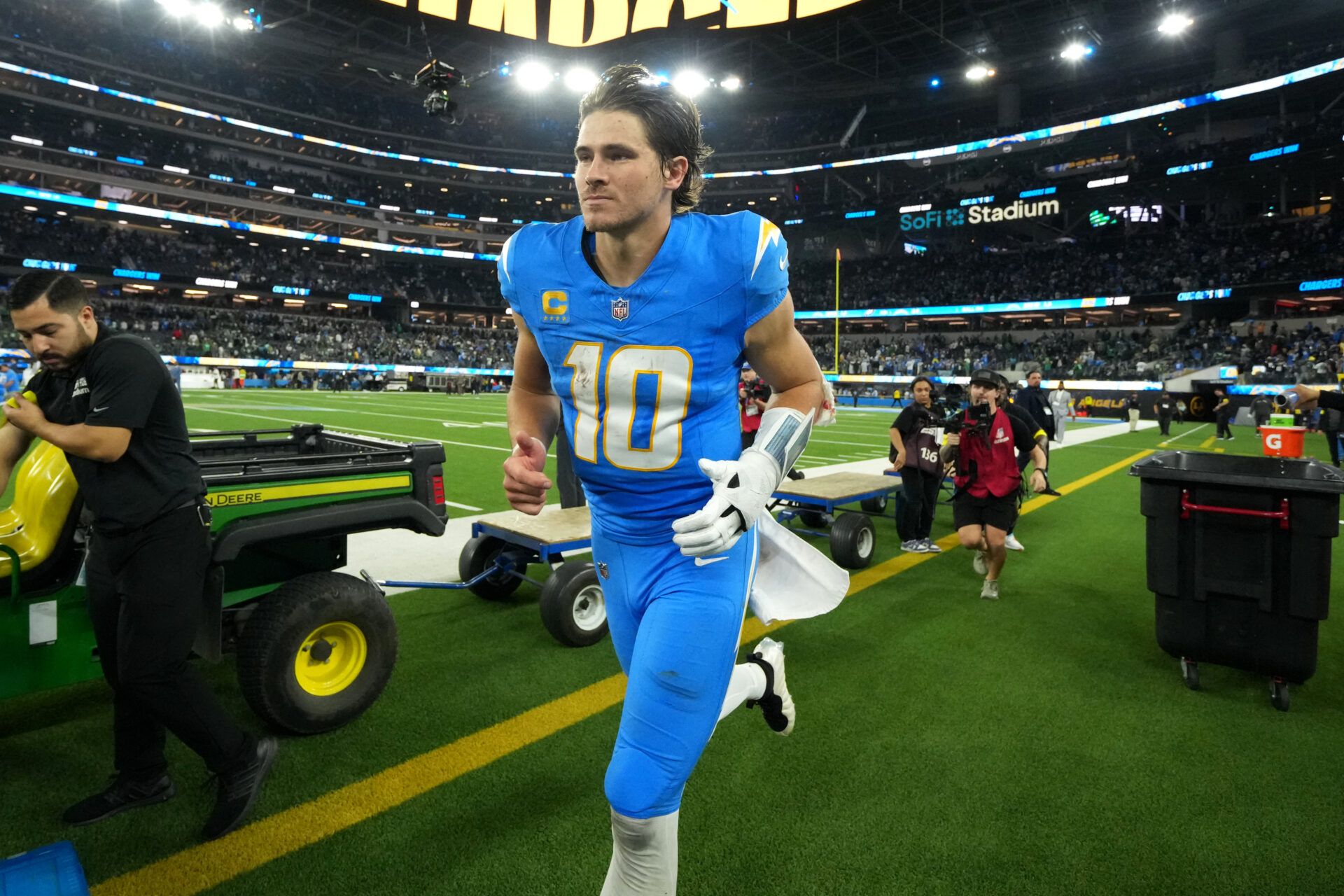 Los Angeles Chargers quarterback Justin Herbert (10) runs off field after defeating the Philadelphia Eagles in overtime at SoFi Stadium.