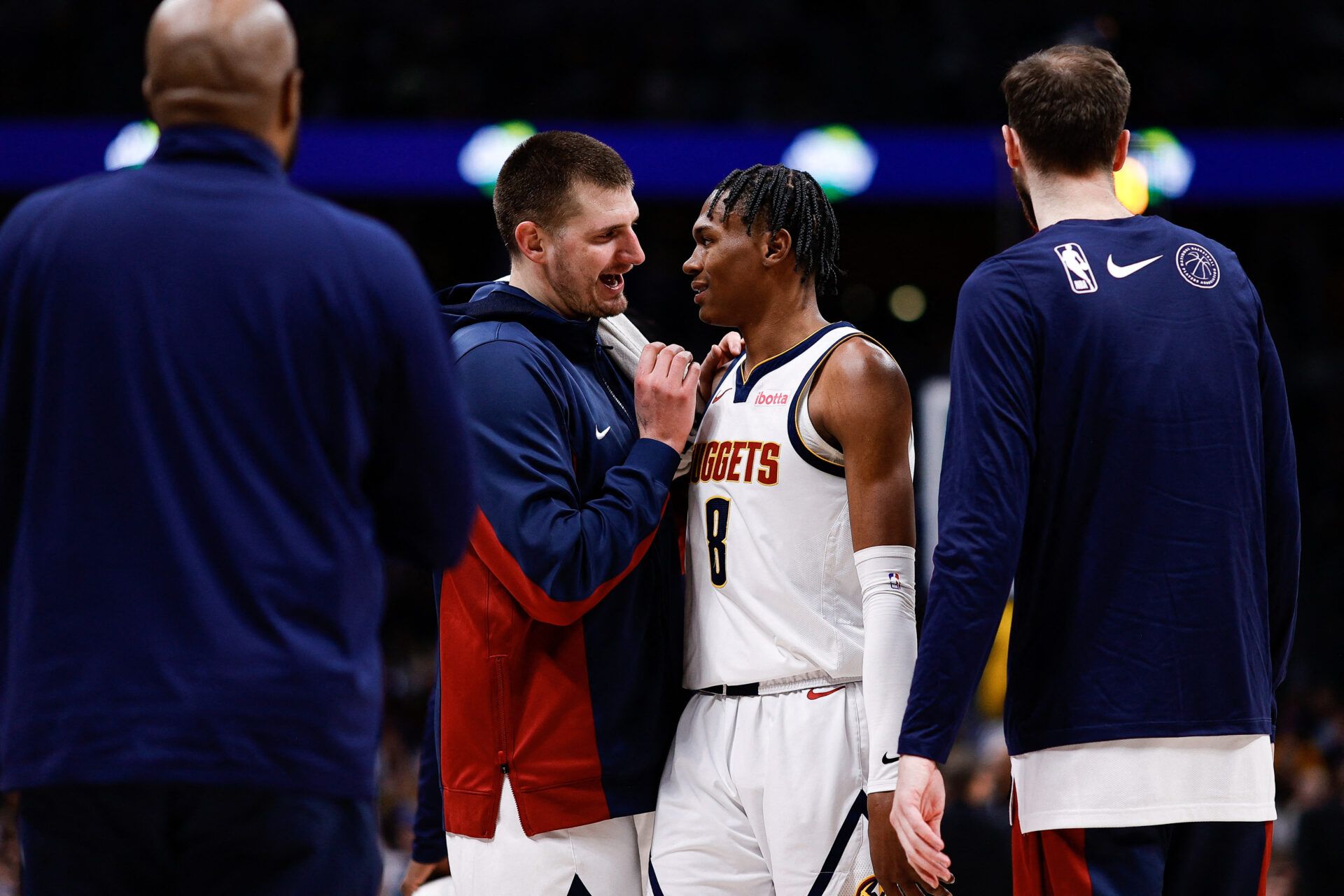 Denver Nuggets center Nikola Jokic (15) talks with forward Peyton Watson (8) after a play in the fourth quarter against the Portland Trail Blazers at Ball Arena.