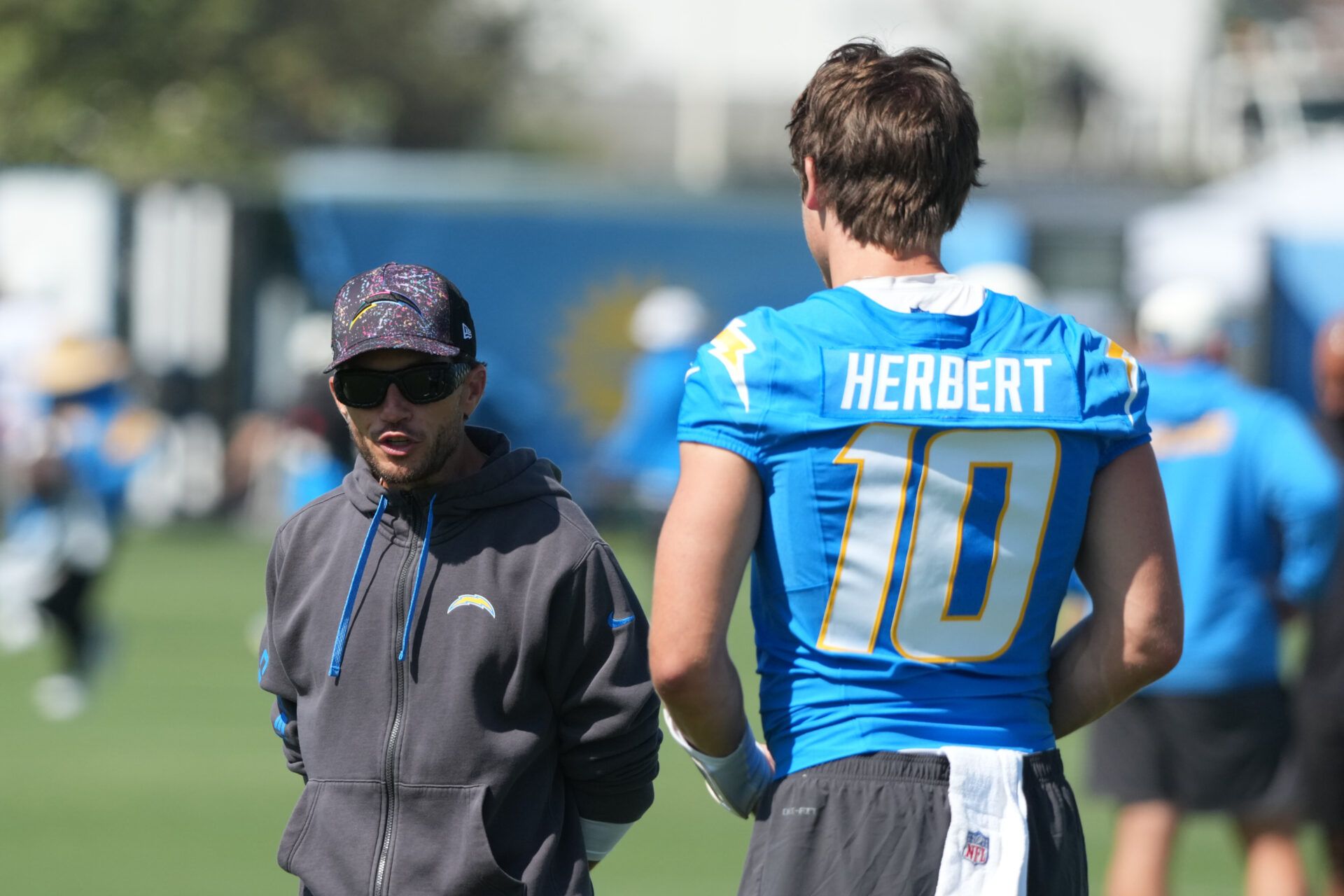 Los Angeles Chargers offensive coordinator Mike McDaniel (left) and quarterback Justin Herbert (10) during training camp at The Bolt.