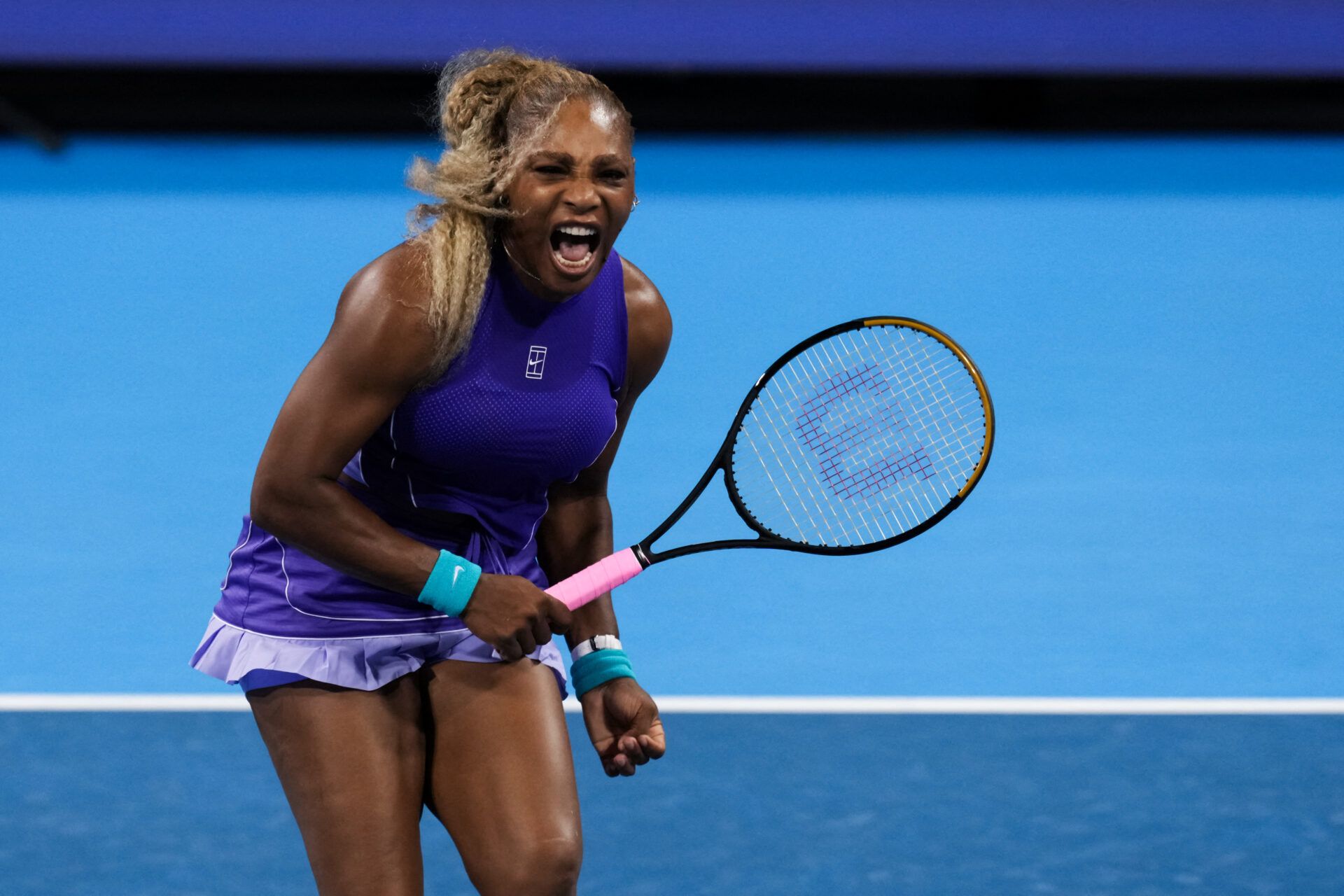 Serena Williams of the United States with partner Venus Williams of the United States, reacts as she returns a shot against Marta Kostyuk of Ukraine and Peyton Stearns of the United States in a doubles match during the Cincinnati Open at Lindner Family Tennis Center.