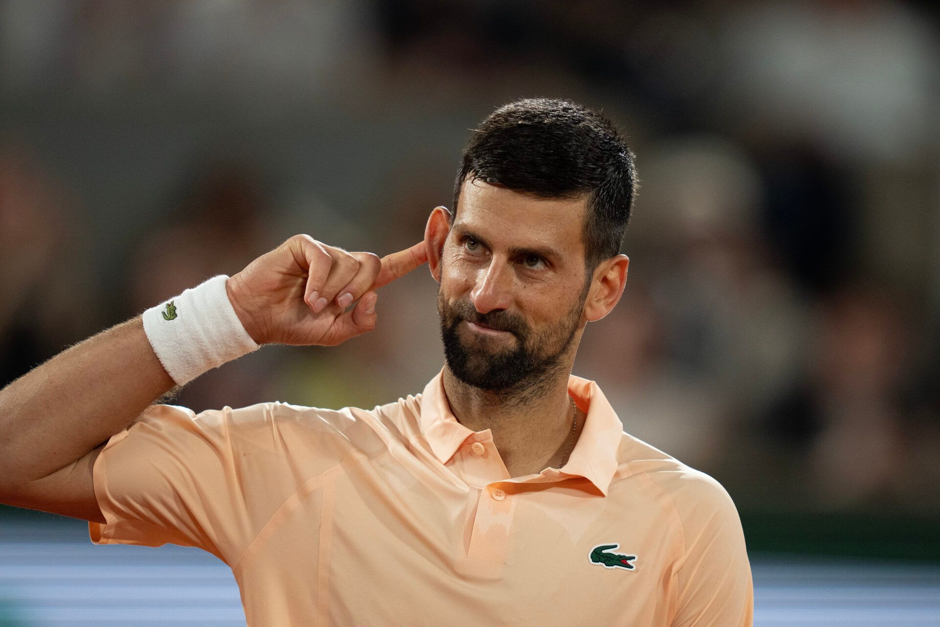 Novak Djokovic of Serbia reacts during his first round match against Giovanni Mpetshi Perricard of France on day one at Stade Roland Garros.