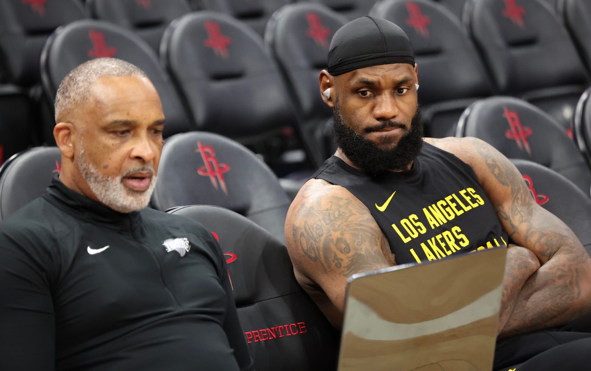 Los Angeles Lakers forward LeBron James (23) looks over video with assistant coach Phil Handy before playing against the Houston Rockets at Toyota Center.