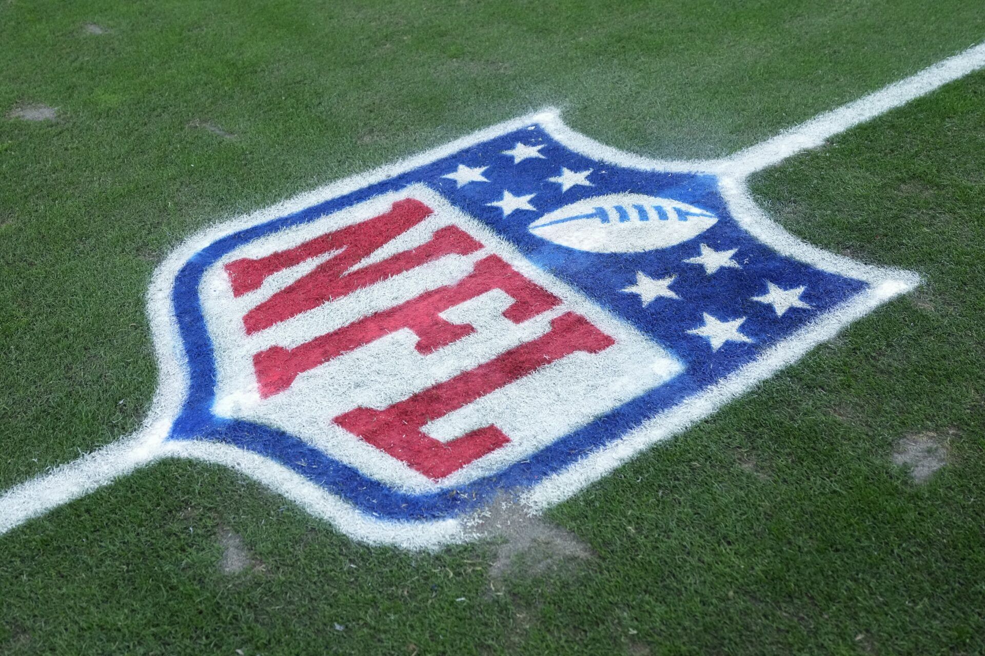 The NFL shield logo on the field at Allegiant Stadium.