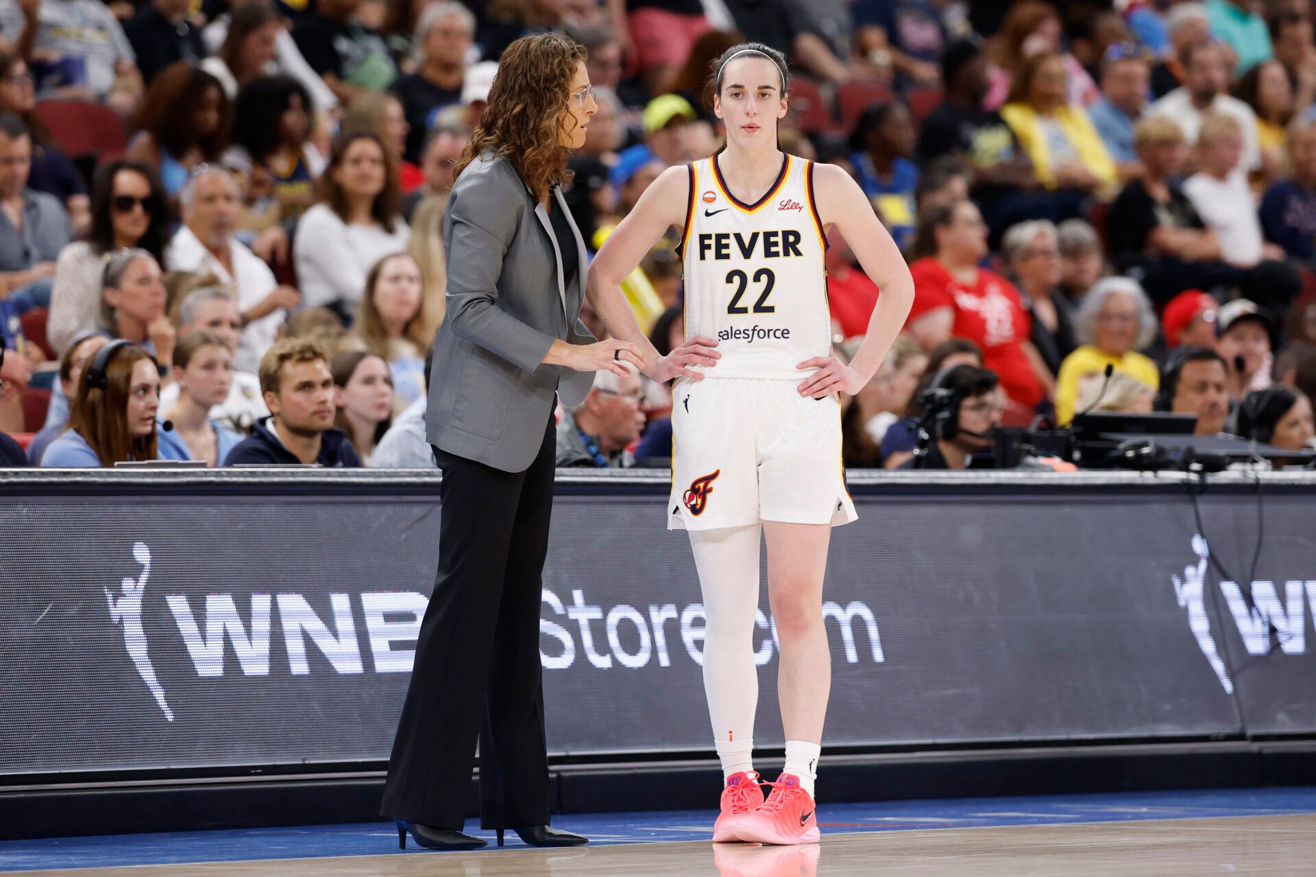 Indiana Fever guard Caitlin Clark (22) talks with head coach Stephanie White during the first half of a WNBA game against the Chicago Sky at United Center.