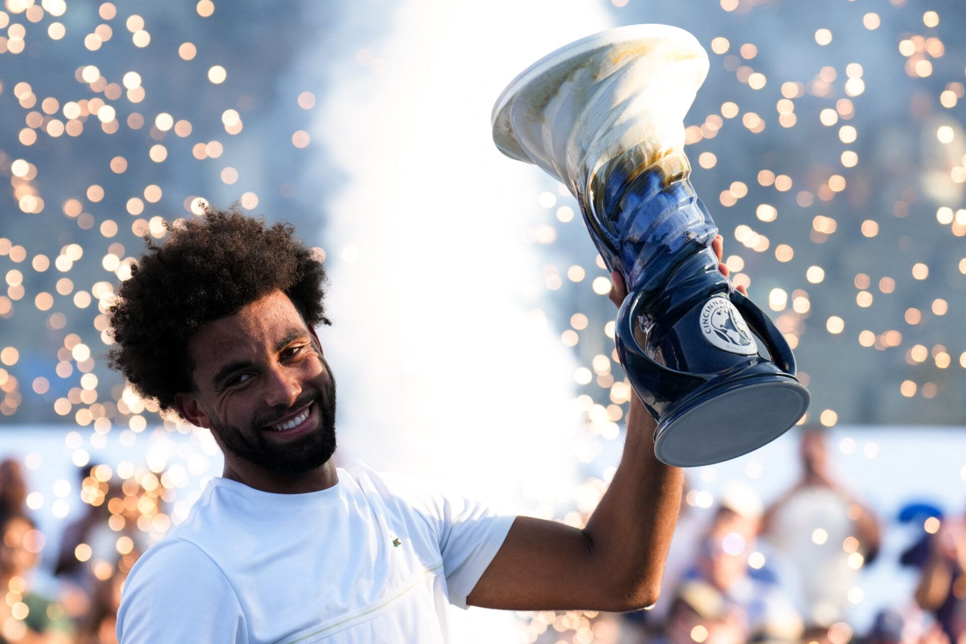 Arthur Fils (FRA) celebrates with the Rookwood Cup after defeating Frances Tiafoe (USA) during the finals of the Cincinnati Open at Lindner Family Tennis Center.