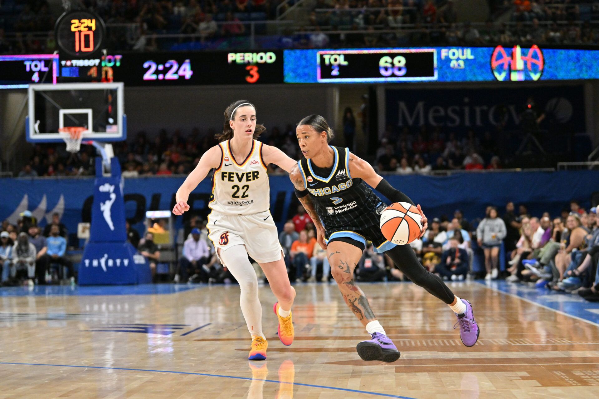 Chicago Sky guard Natasha Cloud (9) drives the ball against Indiana Fever guard Caitlin Clark (22) during the second half at Wintrust Arena.