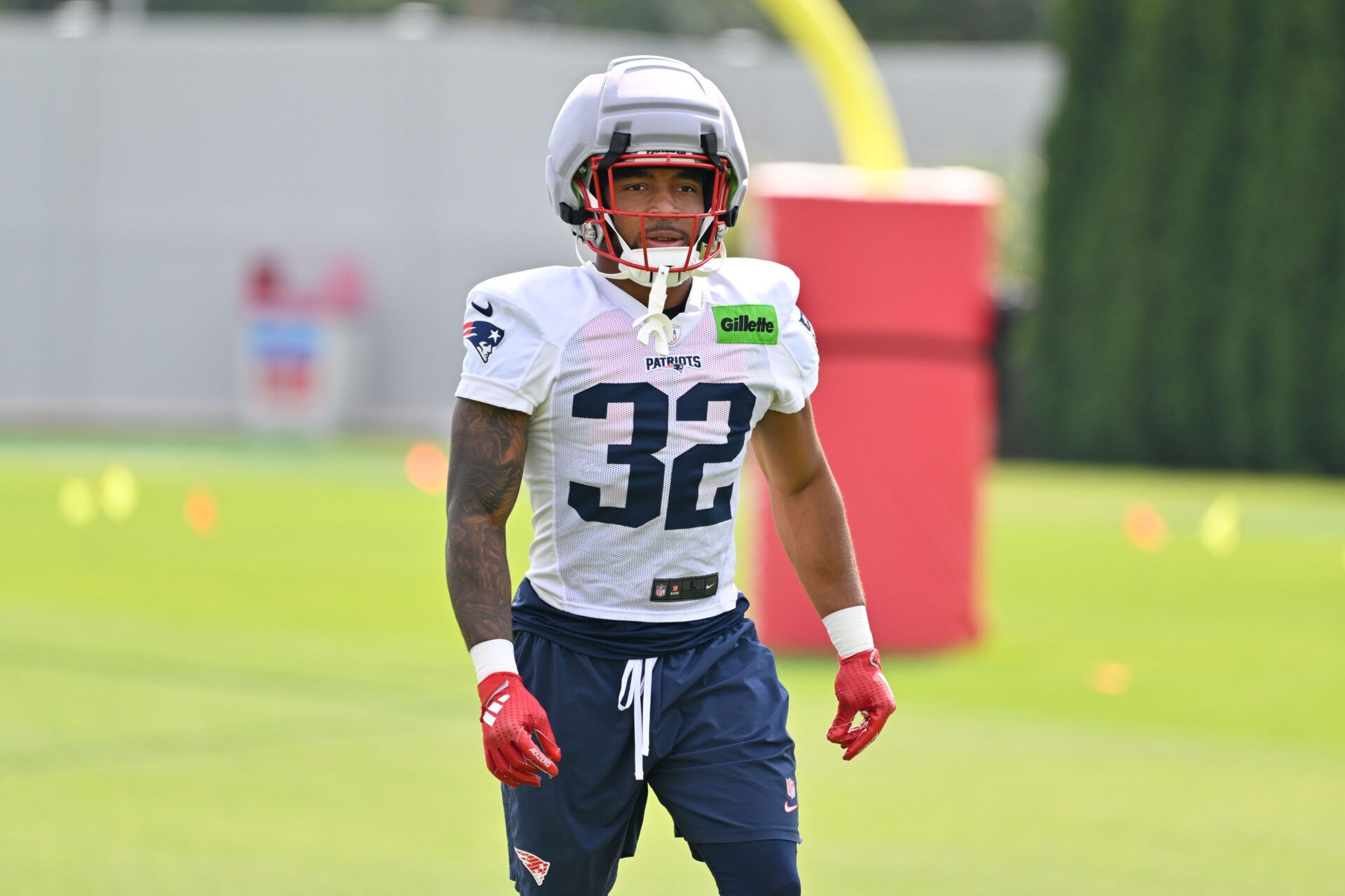New England Patriots running back Treveyon Henderson (32) walks to practice for training camp at Gillette Stadium.