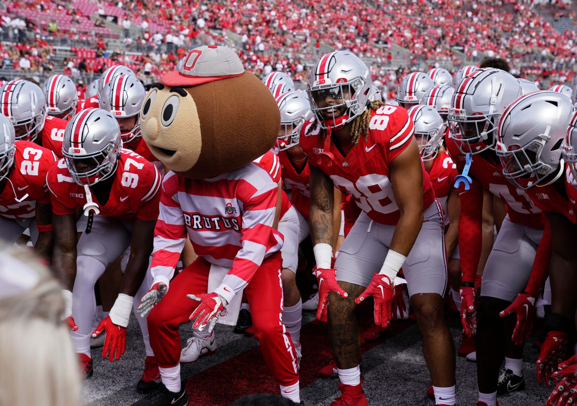 Sept. 9, 2023; Columbus, Oh., USA; 
Brutus Buckeye and Ohio State Buckeyes tight end Gee Scott Jr. (88) take a stance as the Ohio State Buckeyes huddle up before Saturday's NCAA Division I football game against the Youngstown State Penguins at Ohio Stadium.